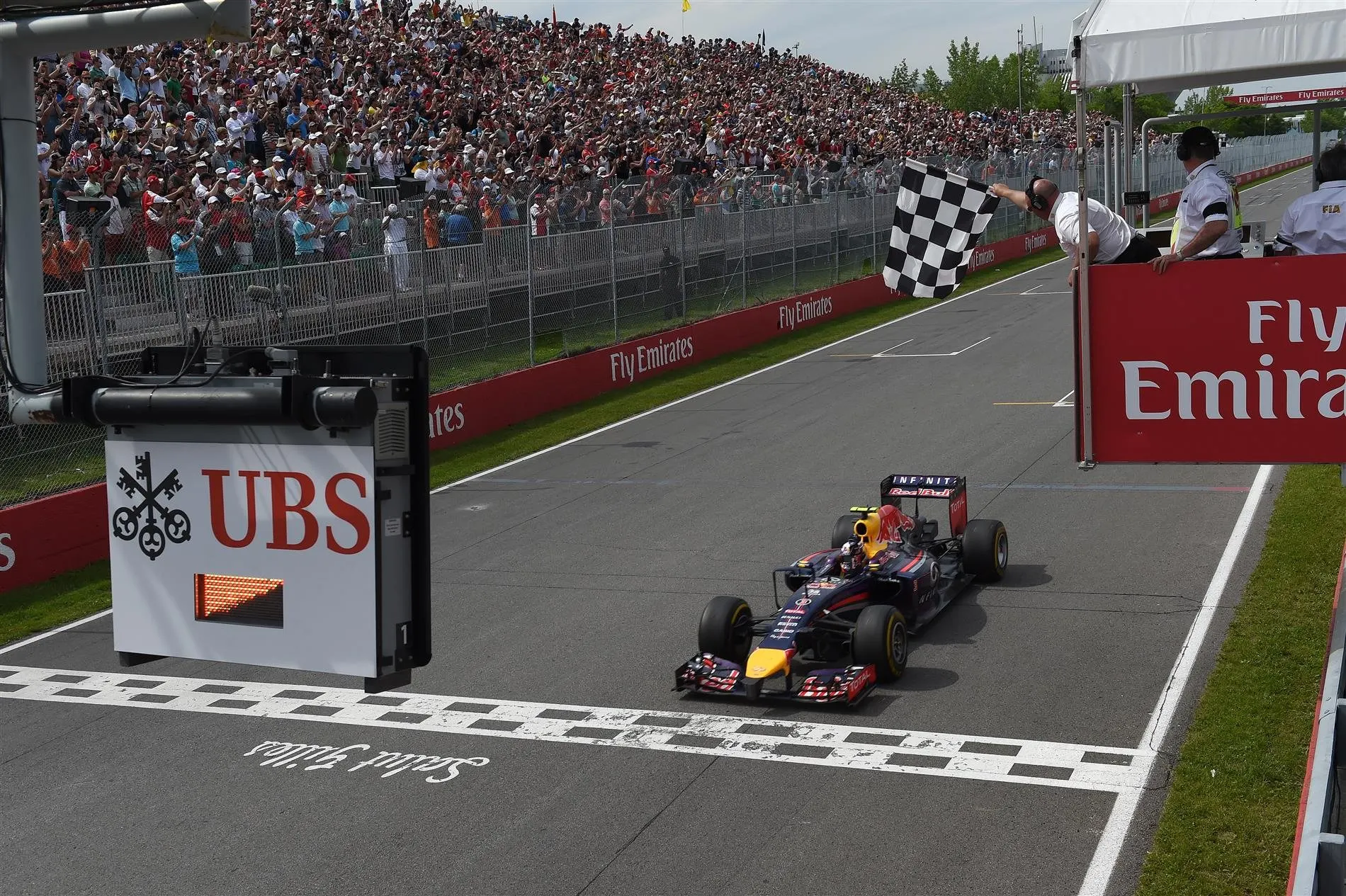 Race winner Daniel Ricciardo (AUS) Red Bull Racing RB10 crosses the line to take the chequered flag. Formula One World Championship, Rd7, Canadian Grand Prix, Race Day, Montreal, Canada, Sunday, 8 June 2014
