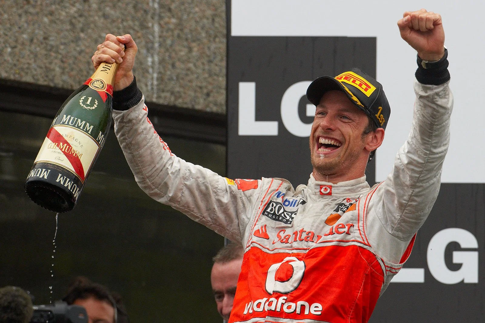 Race winner Jenson Button celebrates his victory on the podium