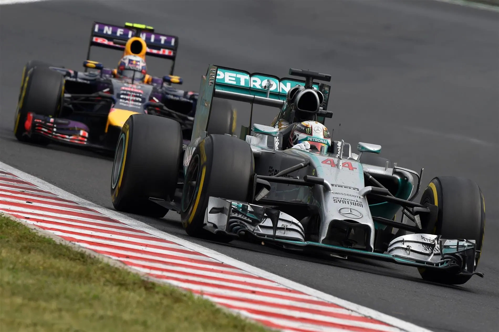 Lewis Hamilton (GBR) Mercedes AMG F1 W05 leads Daniel Ricciardo (AUS) Red Bull Racing RB10. Formula One World Championship, Rd11, Hungarian Grand Prix, Race Day, Hungaroring, Hungary. Sunday, 27 July 2014