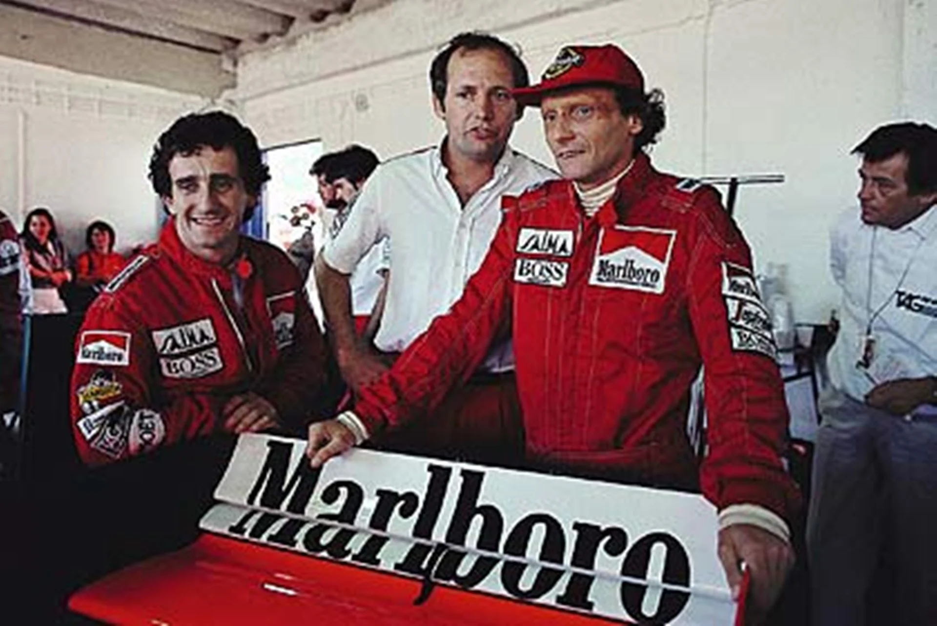 Estoril, October 1984: Niki Lauda pictured with McLaren team mate Alain Prost (left) and team boss