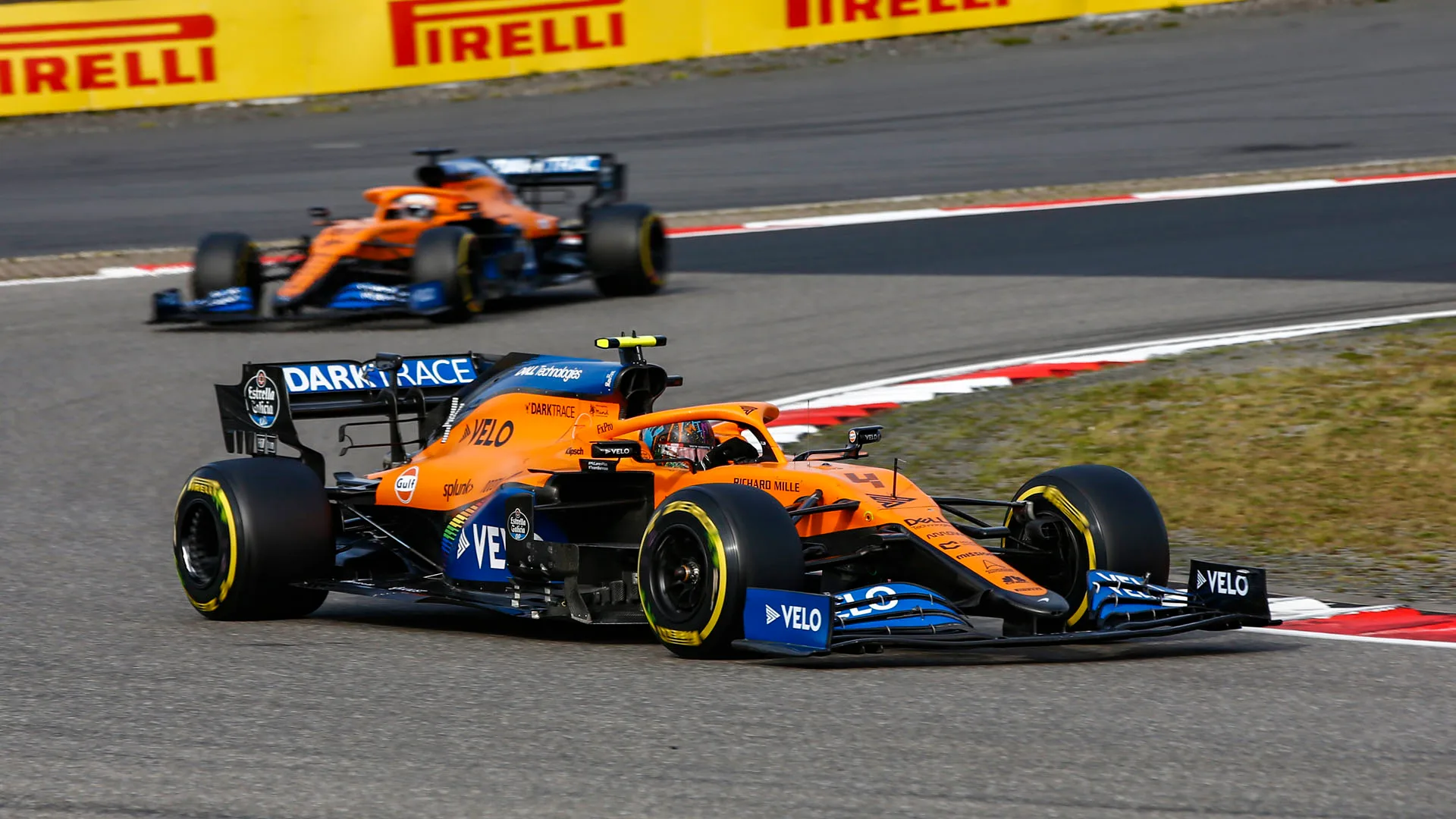 Lando Norris, McLaren MCL35, leads Carlos Sainz, McLaren