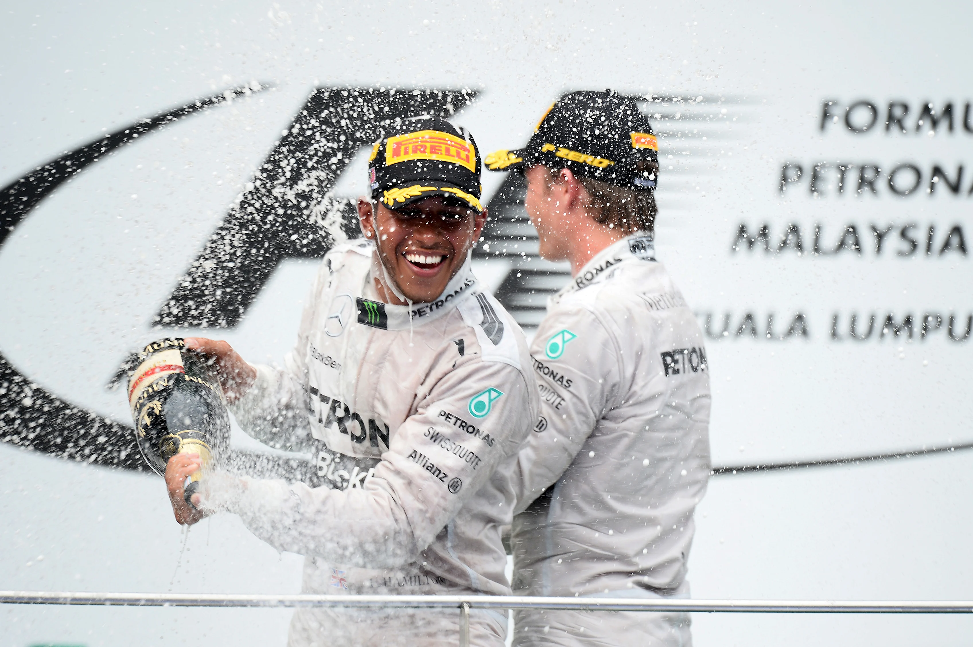 (L to R): race winner Lewis Hamilton (GBR) Mercedes AMG F1 and Nico Rosberg (GER) Mercedes AMG F1 celebrate on the podium with the champagne
Formula One World Championship, Rd2, Malaysian Grand Prix, Race, Sepang, Malaysia, Sunday 30 March 2014. © Sutton Images