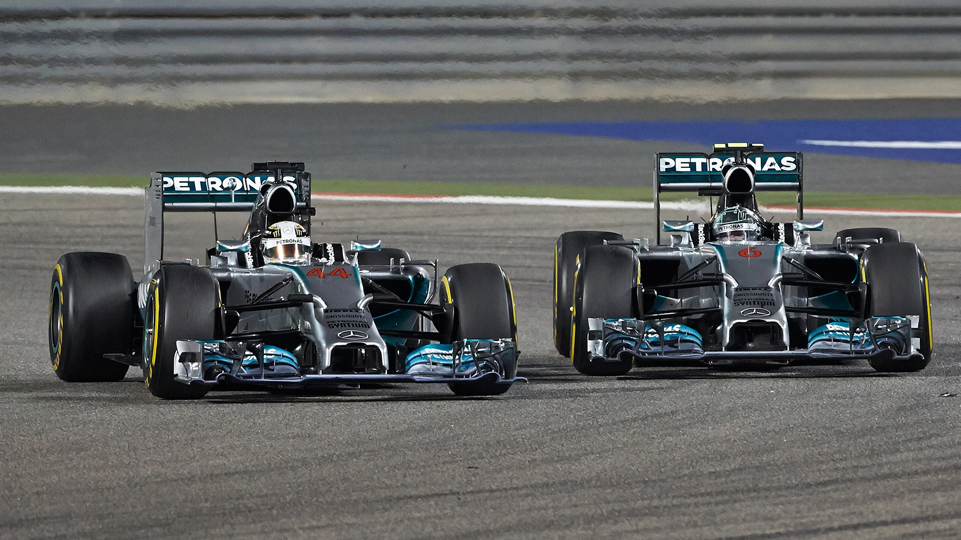 SAKHIR, BAHRAIN - APRIL 06: Lewis Hamilton (L) of Great Britain and Mercedes GP leads from team