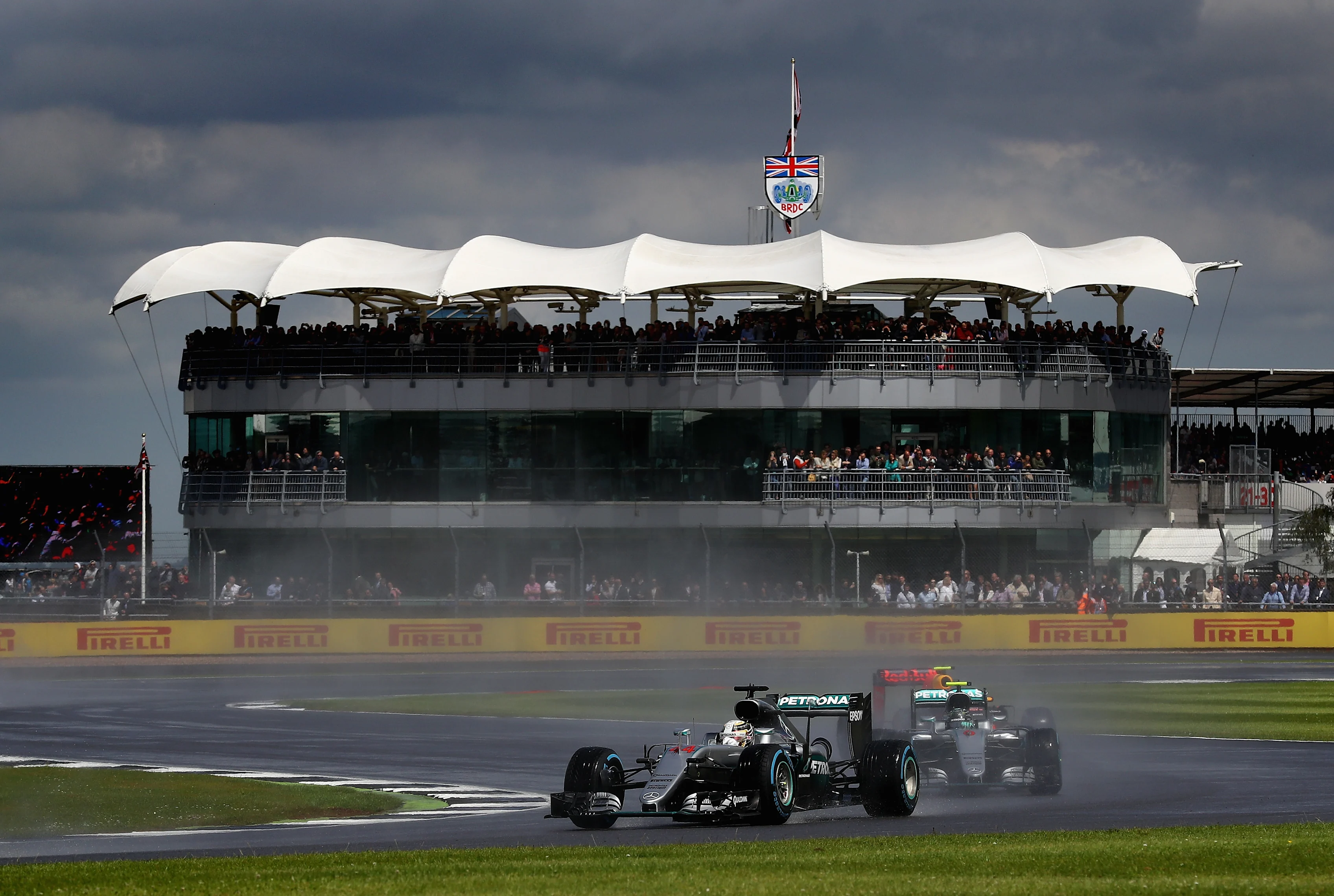 NORTHAMPTON, ENGLAND - JULY 10: Lewis Hamilton of Great Britain and Mercedes GP leads team mate