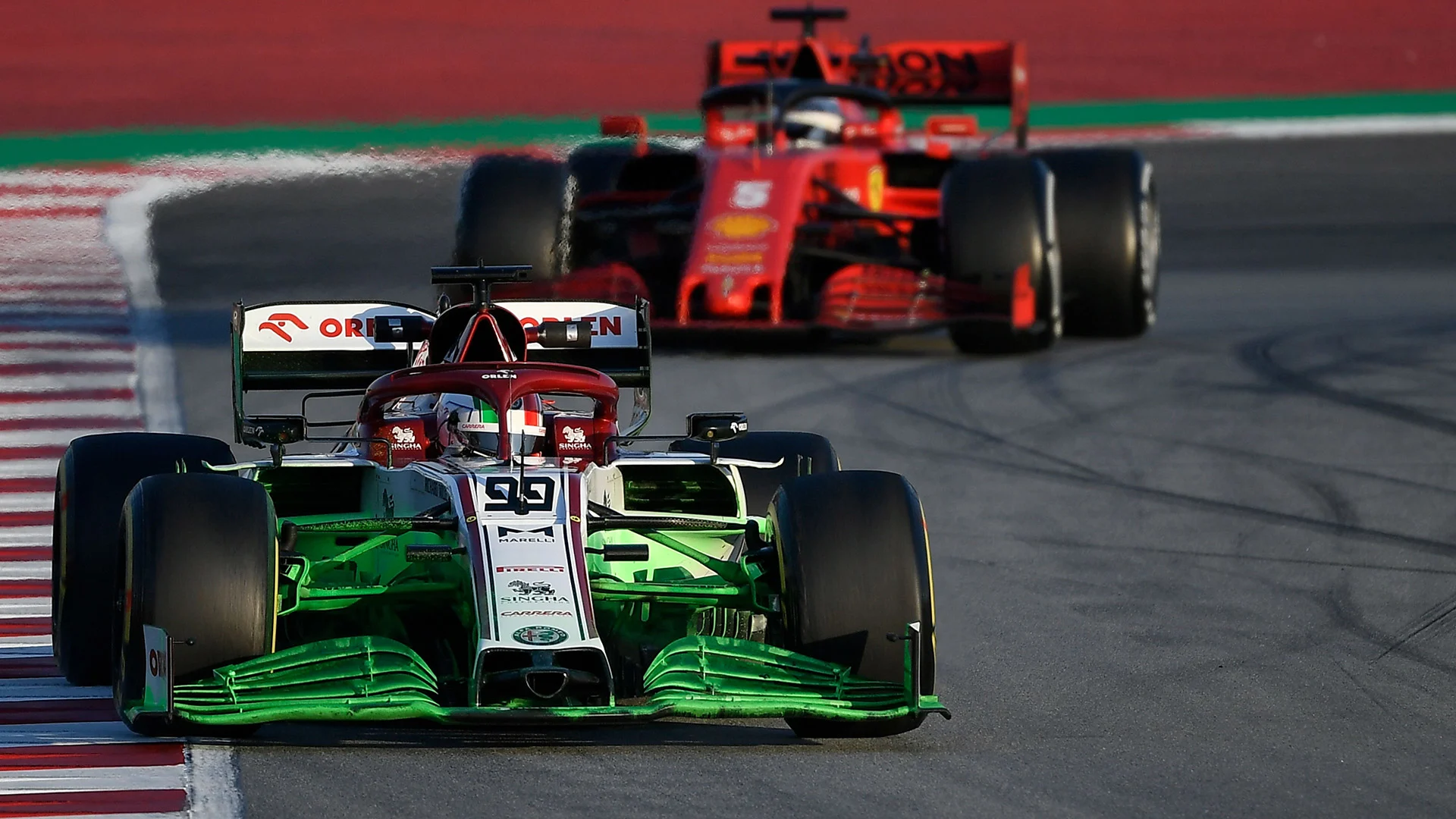 Alfa Romeo's Italian driver Antonio Giovinazzi drives ahead of Ferrari's German driver Sebastian