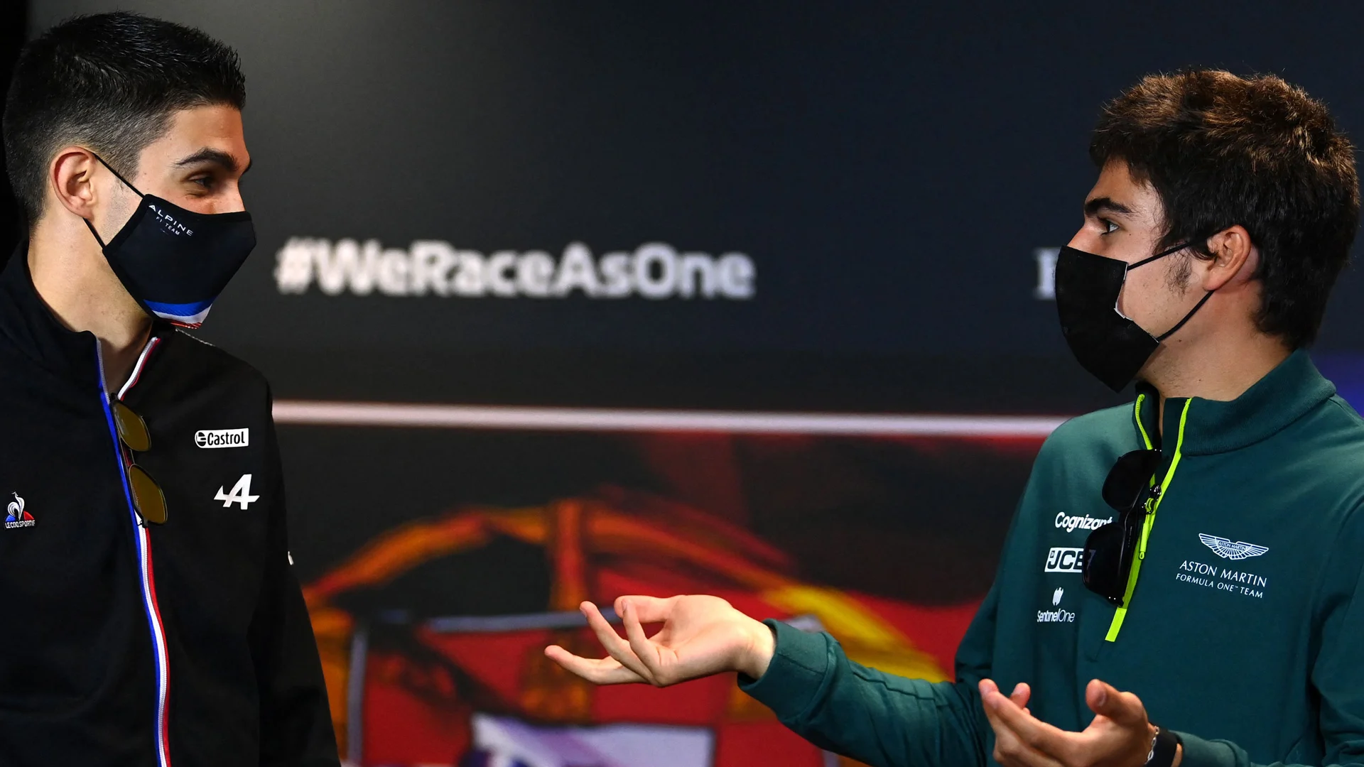 Alpine's French driver Esteban Ocon and Aston Martin's Canadian driver Lance Stroll (R) attend the