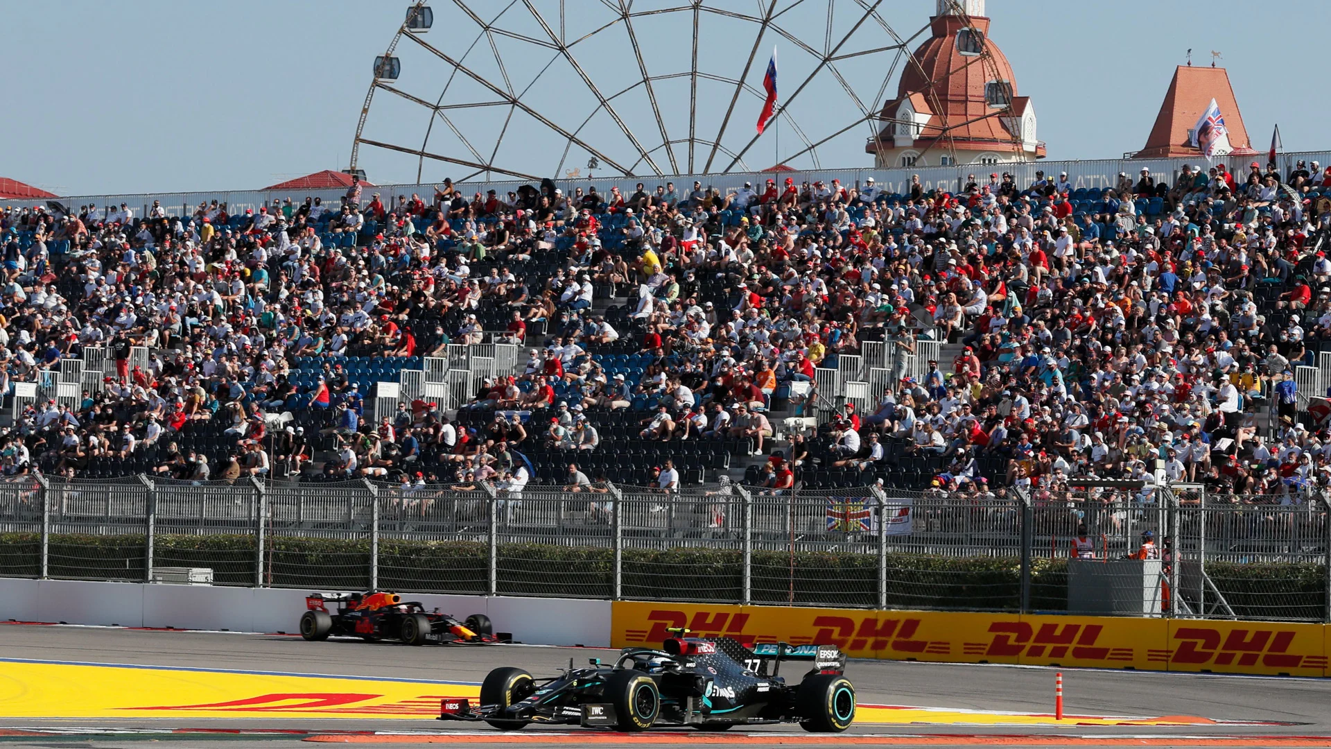 Mercedes' Finnish driver Valtteri Bottas (R) steers his car past Red Bull's Dutch driver Max