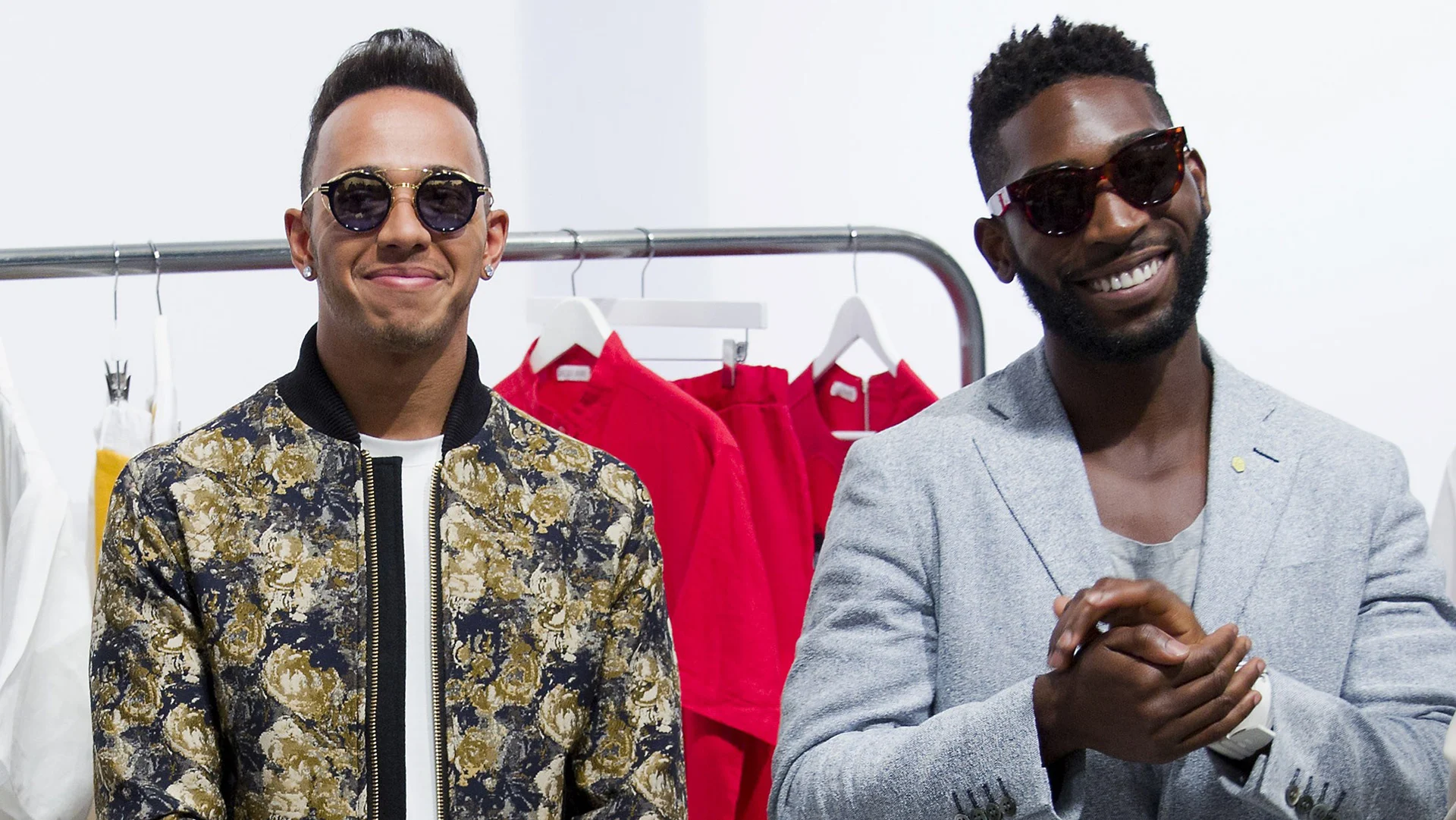 British Formula One racing driver Lewis Hamilton (L) and British musician Tinie Tempah (R) attend a