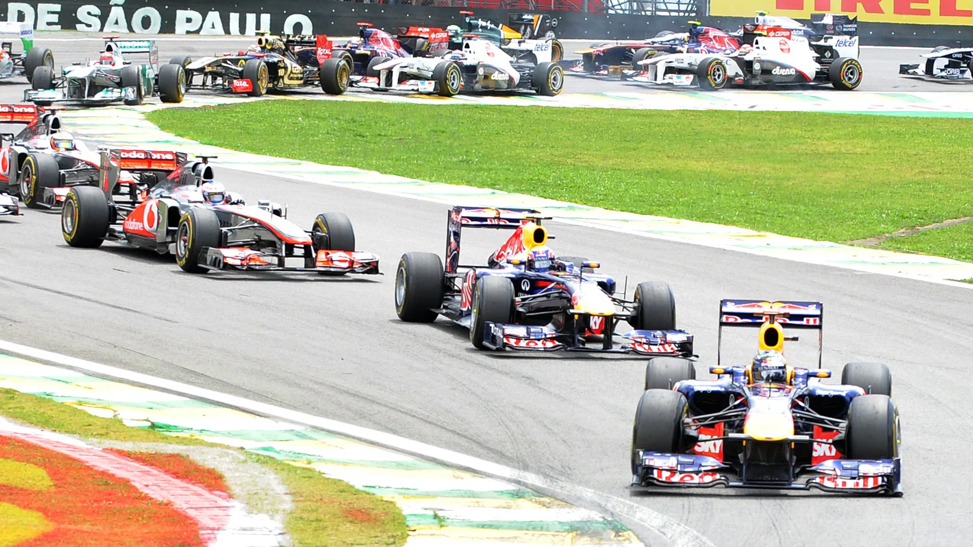 German F-1 driver and 2011 F-1 World Champion Sebastian Vettel leads the first lap of the 2011