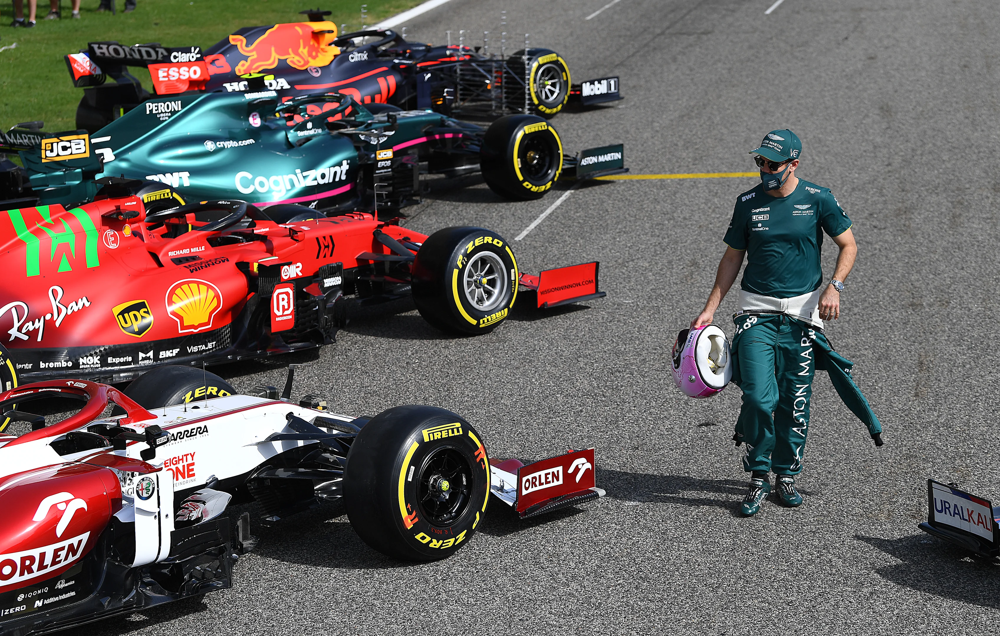 BAHRAIN, BAHRAIN - MARCH 12: Sebastian Vettel of Germany and Aston Martin walks amongst the cars on