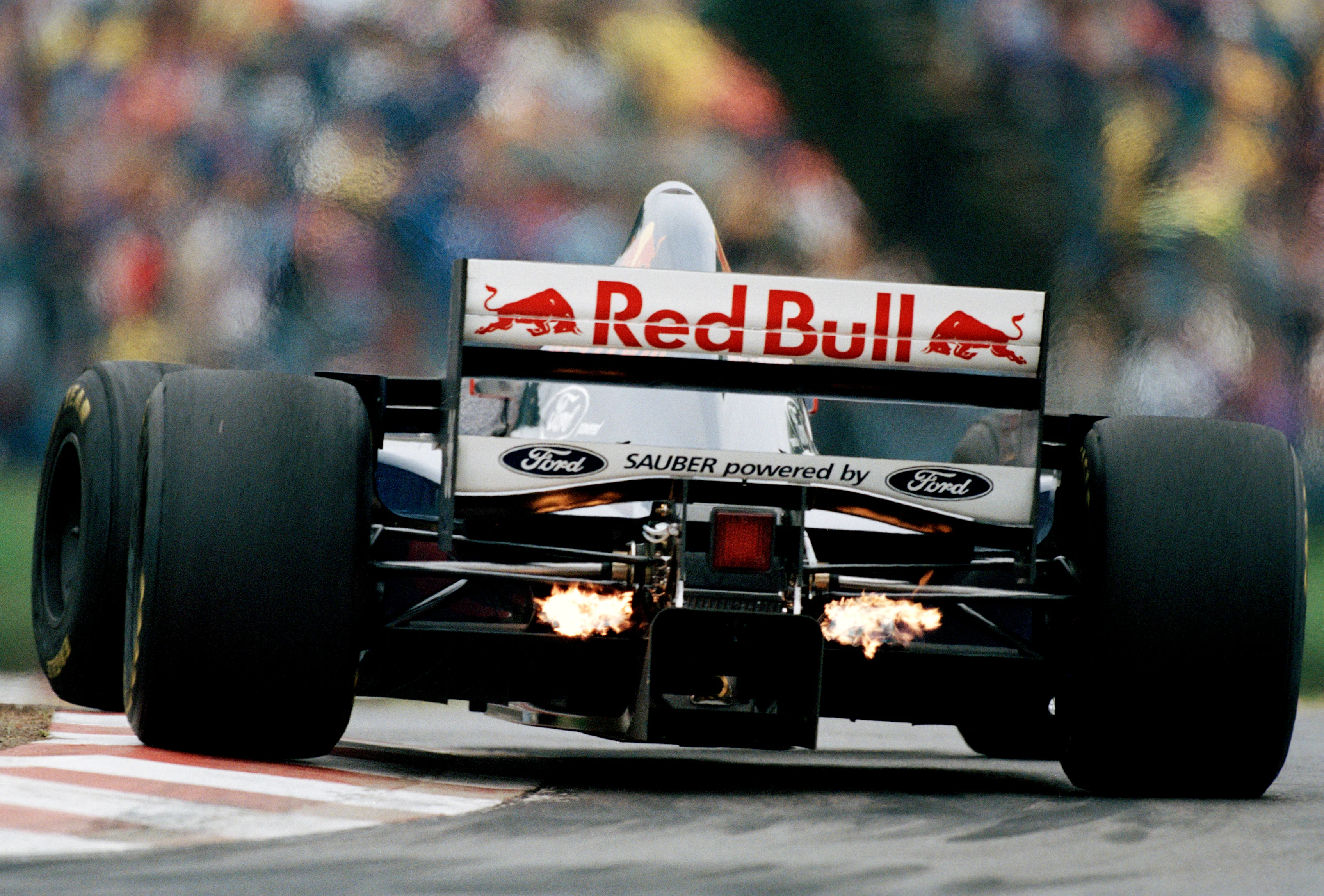 Flames flash from the exhausts of the #30 Red Bull Sauber Ford Sauber C14 Ford Zetec-R 3.0 V8