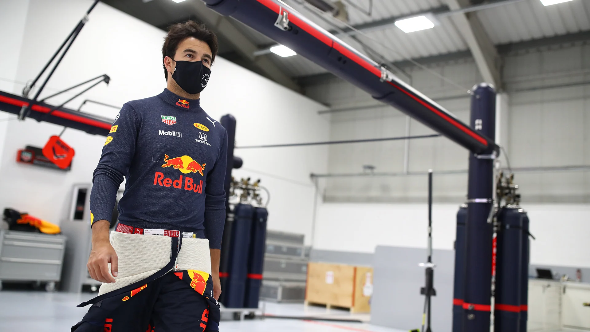 MILTON KEYNES, ENGLAND - JANUARY 12: Sergio Perez of Mexico and Red Bull Racing walks in the