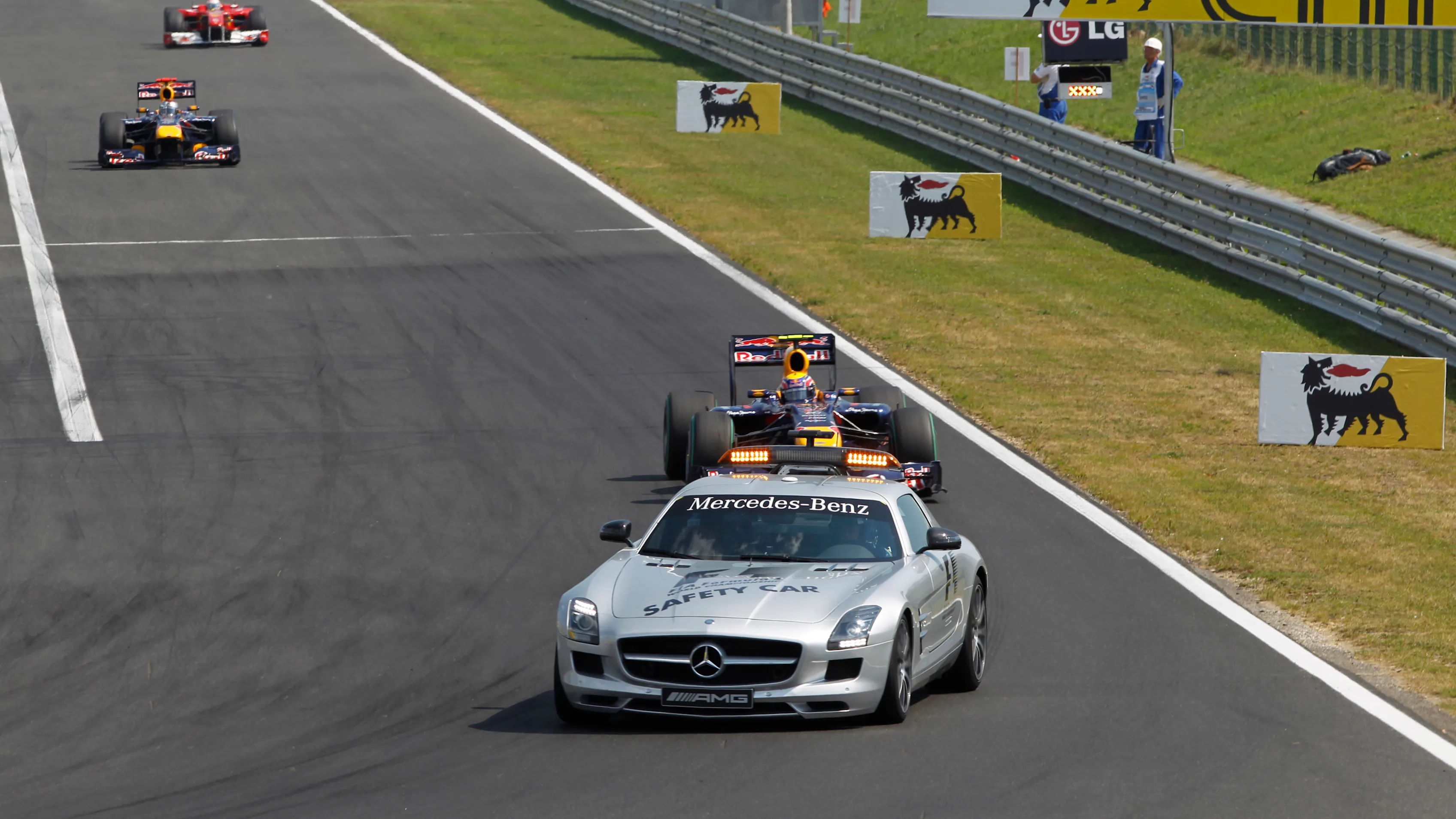 The Safety Car leads Mark Webber, Red Bull Racing RB6 Renault, 1st position, Sebastian Vettel, Red Bull Racing RB6 Renault, 3rd position, and Fernando Alonso, Ferrari F10, 2nd position. © LAT Photographic