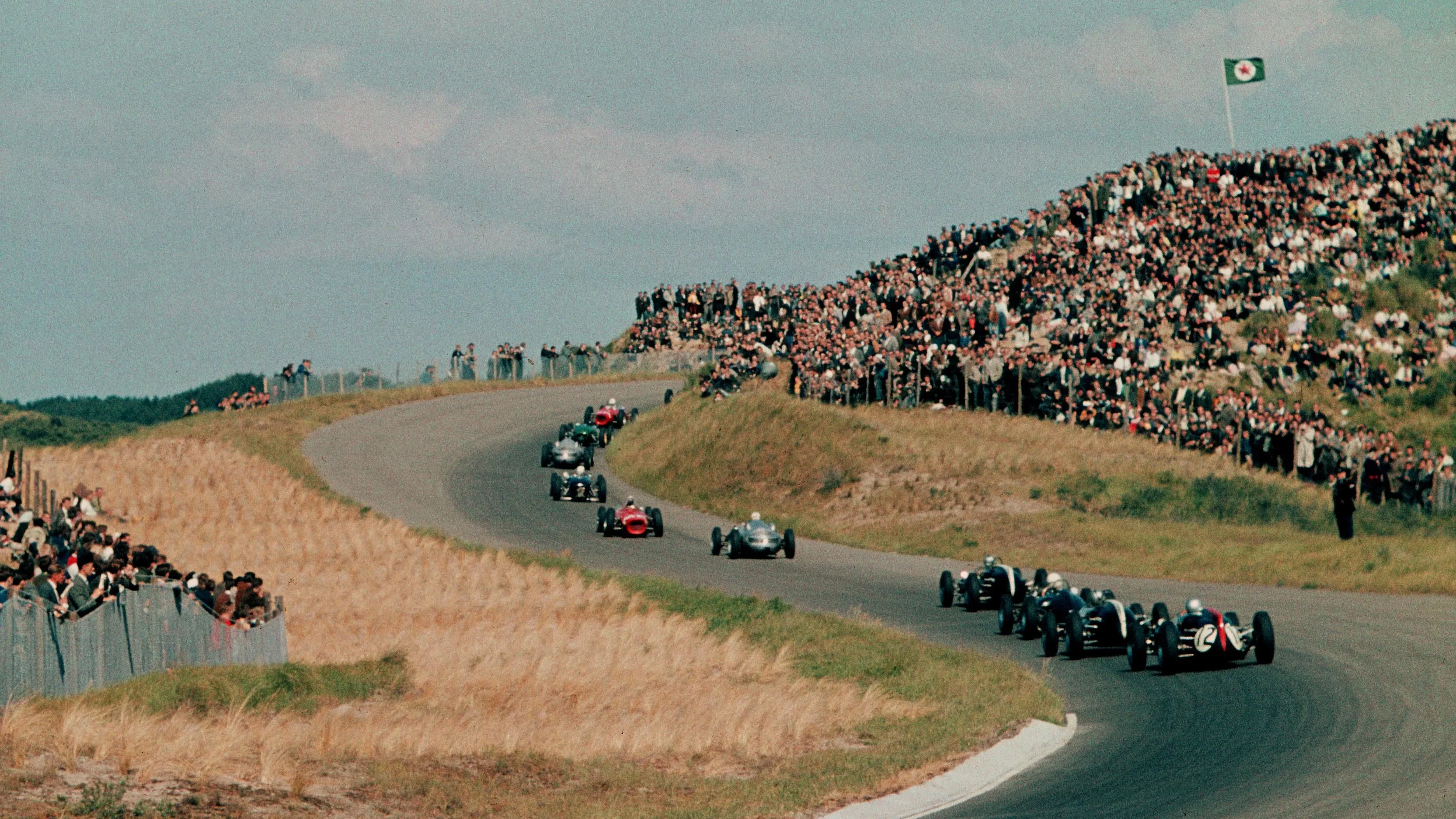 The field winds it's way through the dunes on lap one Dutch GP, Zandvoort, 22 May 1961