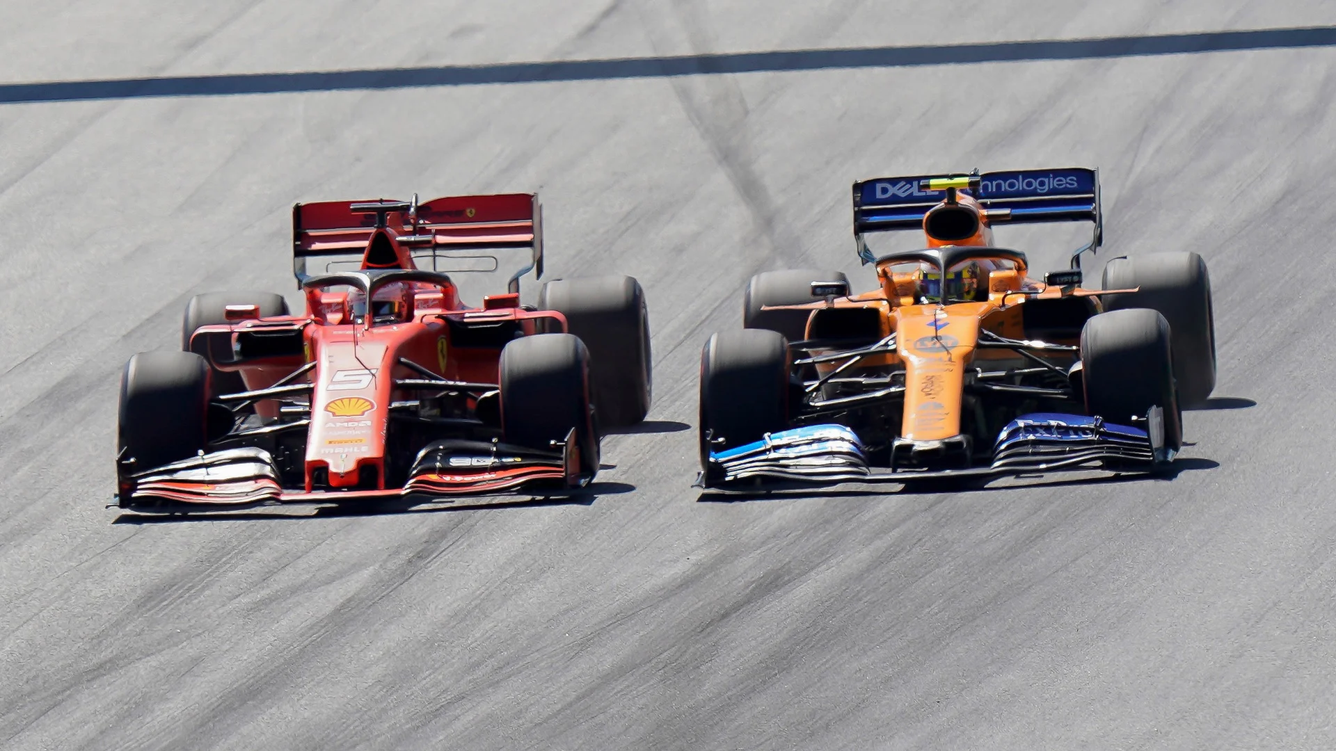 SPIELBERG, AUSTRIA - JUNE 30: Sebastian Vettel of Germany and Ferrari and Lando Norris of Great