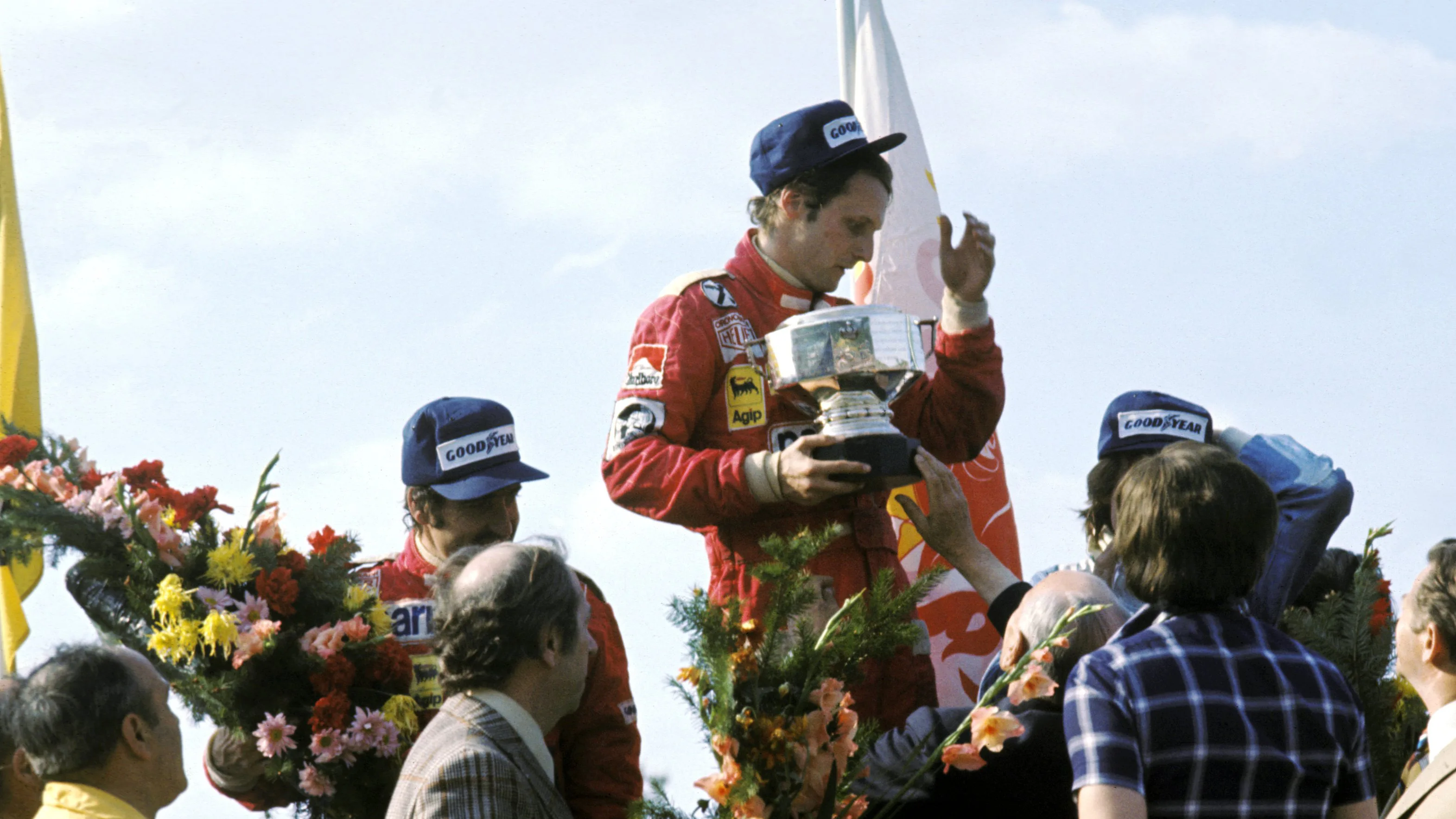 The podium (L to R): Clay Regazzoni (SUI) Ferrari, second; Niki Lauda (AUT) Ferrari, winner;