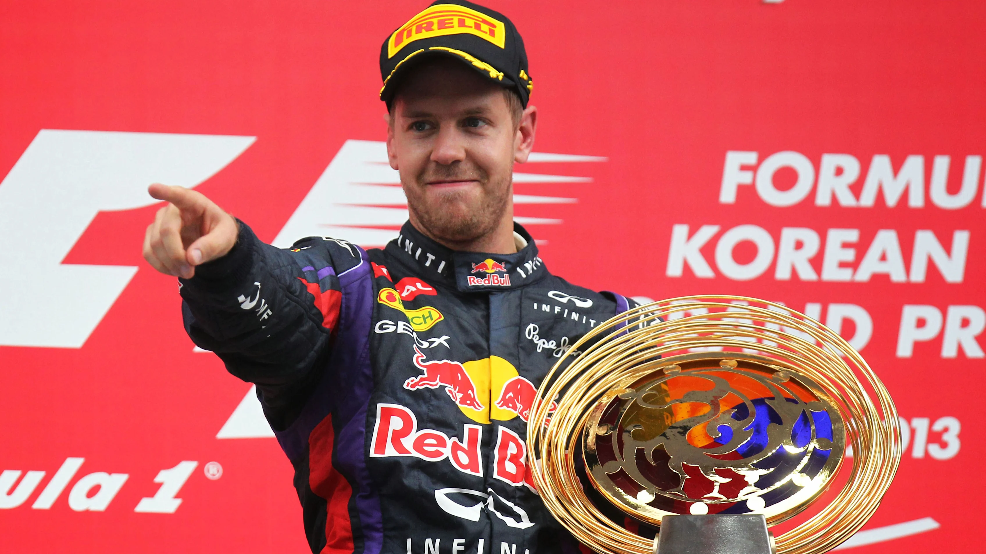 Race winner Sebastian Vettel (GER) Red Bull Racing celebrates with his trophy on the