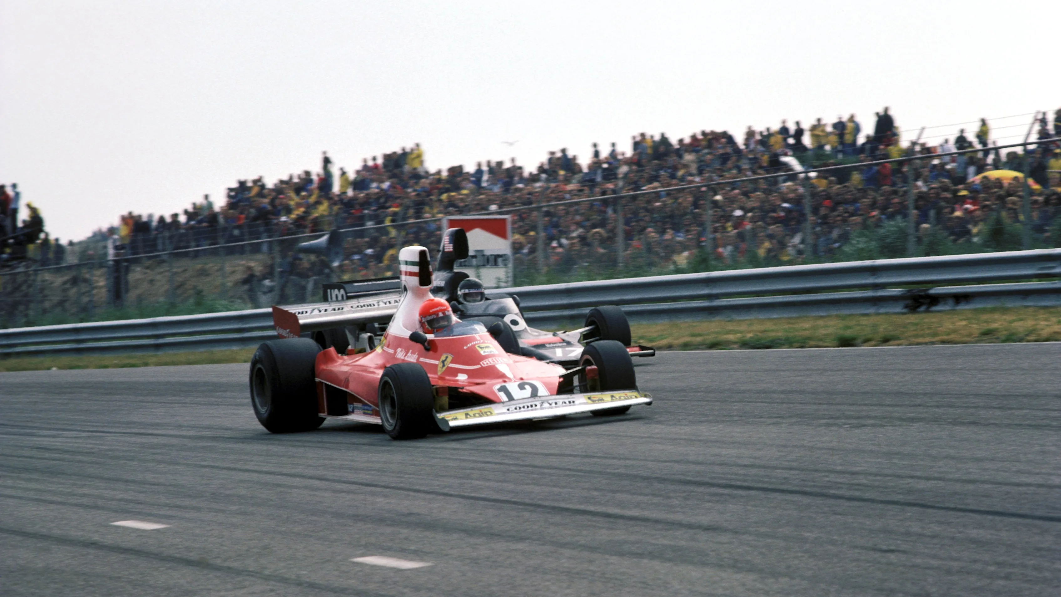 Second place finisher Niki Lauda (AUT) Ferrari 312T overtakes Jean-Pierre Jarier (FRA) Shadow DN5 ,