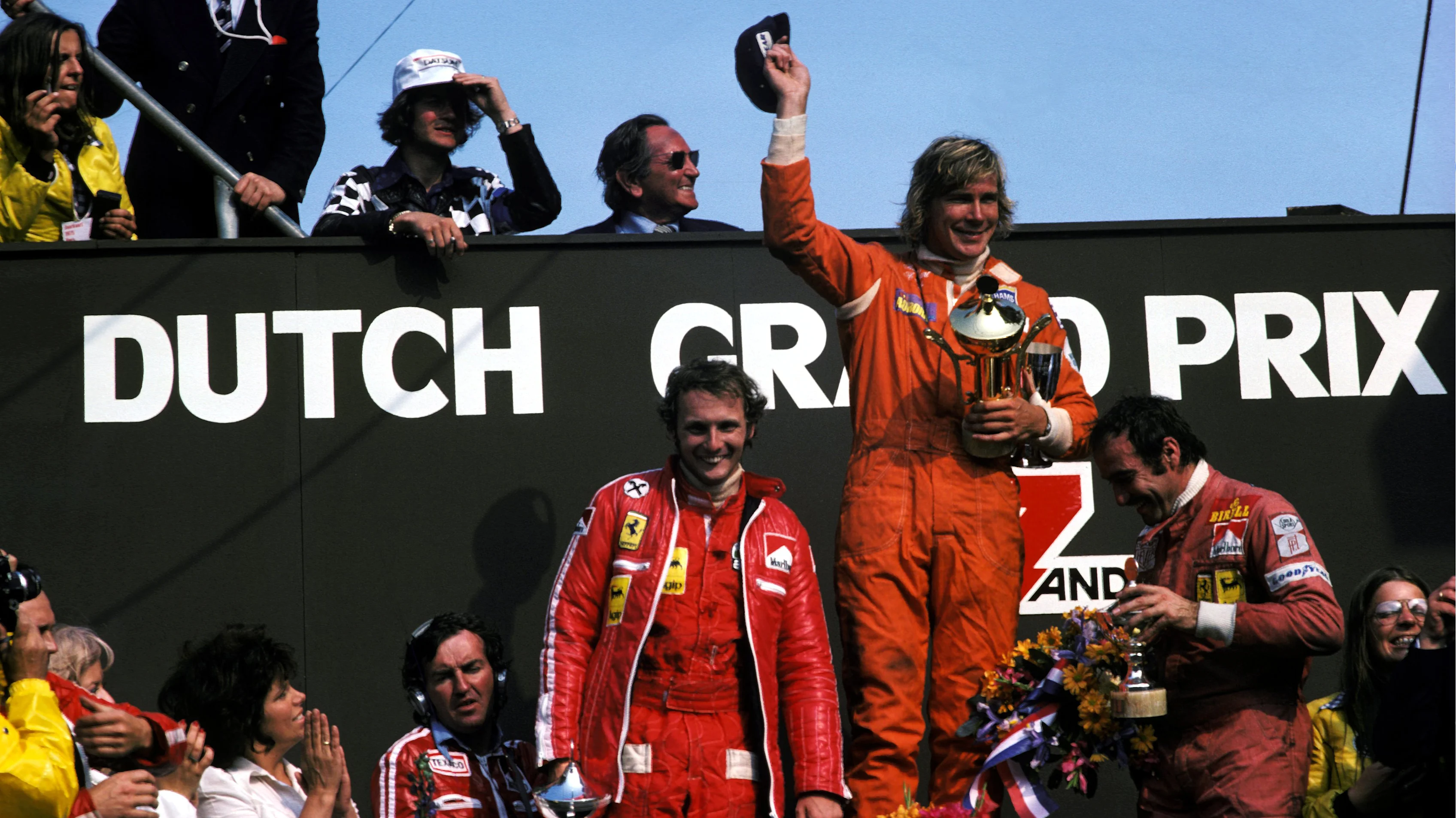 The podium (L to R): Niki Lauda (AUT) Ferrari, second; James Hunt (GBR) Hesketh, winner for the