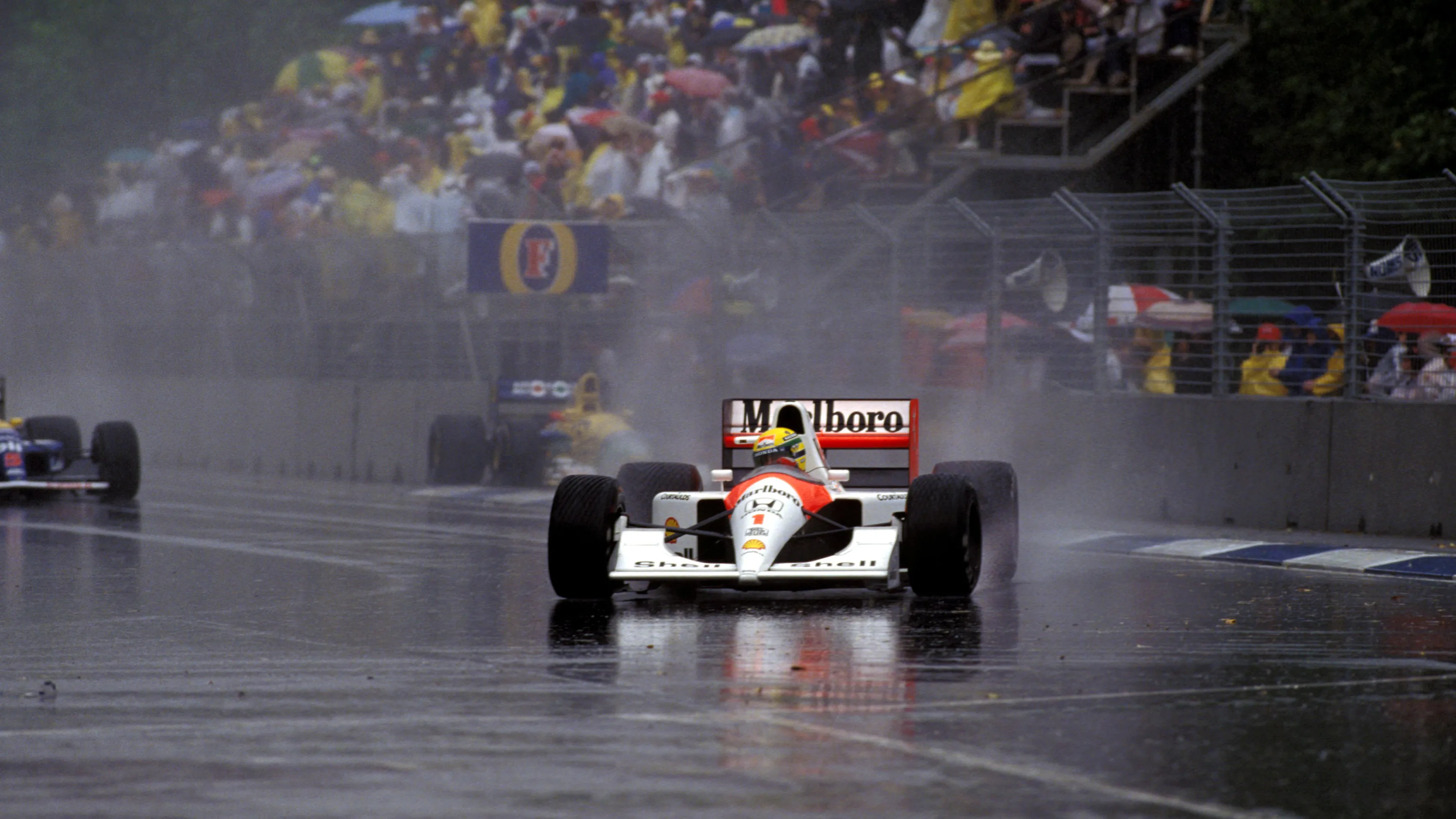 Race winner Ayrton Senna (BRA) McLaren MP4/6 leads in the appalling conditions that stopped the