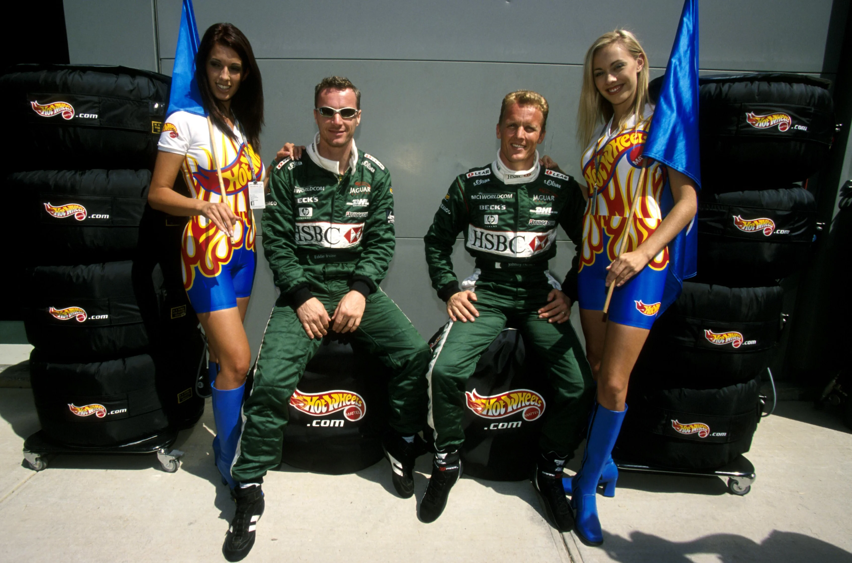 Eddie Irvine(GBR) Jaguar Cosworth R1 and Johnny Herbert(GBR) Jaguar Cosworth R1 with local