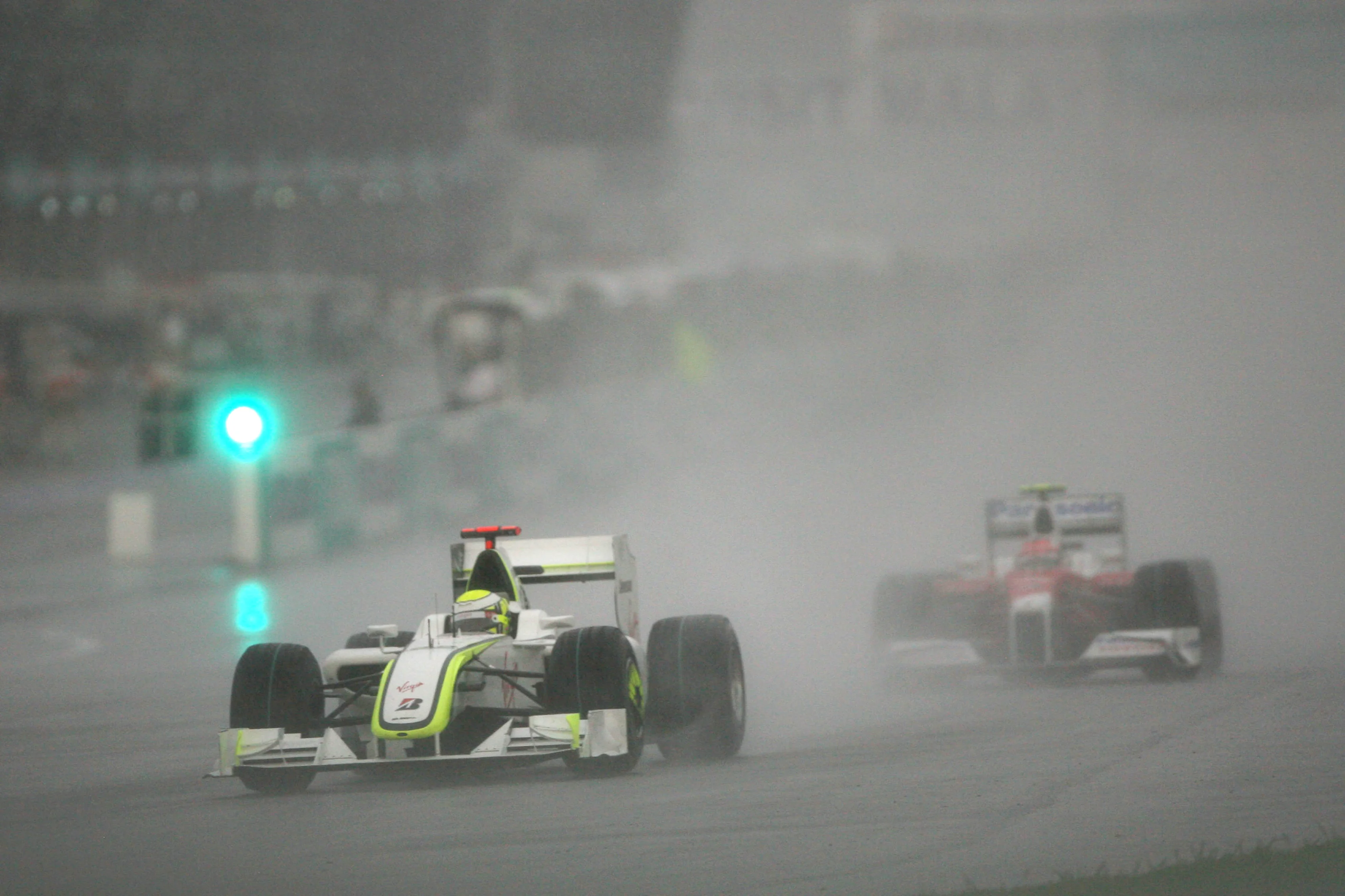 Jenson Button (GBR) Brawn Grand Prix BGP 001 leads Timo Glock (GER) Toyota TF109.  Formula One