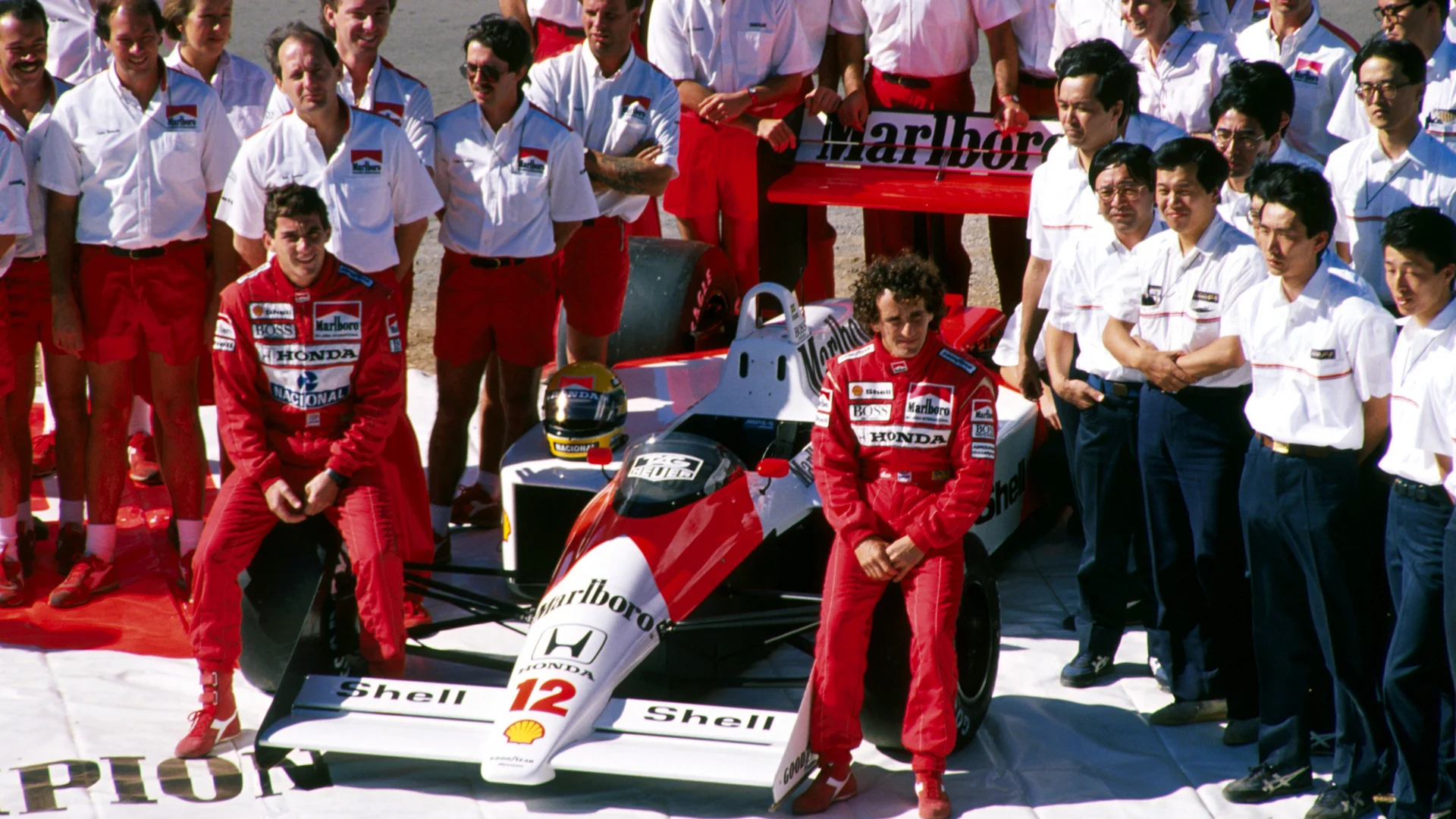Ayrton Senna (BRA) (Left) and Alain Prost (FRA) (Right) the McLaren Honda team celebrate winning both constructors and drivers championship in record breaking style. McLaren team principal Ron Dennis (GBR) is standing behind Senna. Australian Grand Prix, Adelaide, Australia,13 November 1988.
 © Sutton Motorsport Images