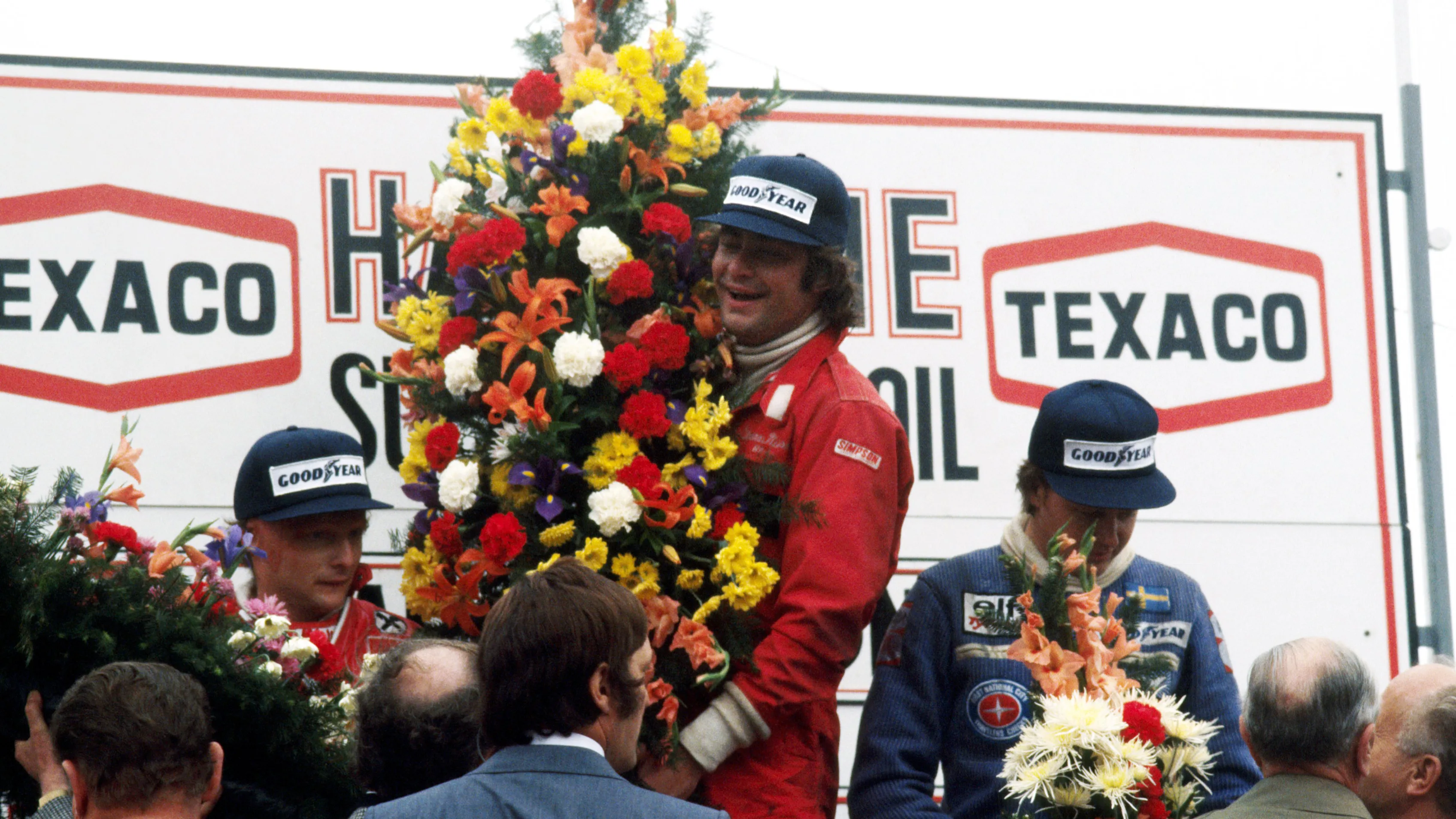 The podium (L to R): Niki Lauda (AUT) Ferrari, second; Gunnar Nilsson (SWE) Lotus, celebrating his