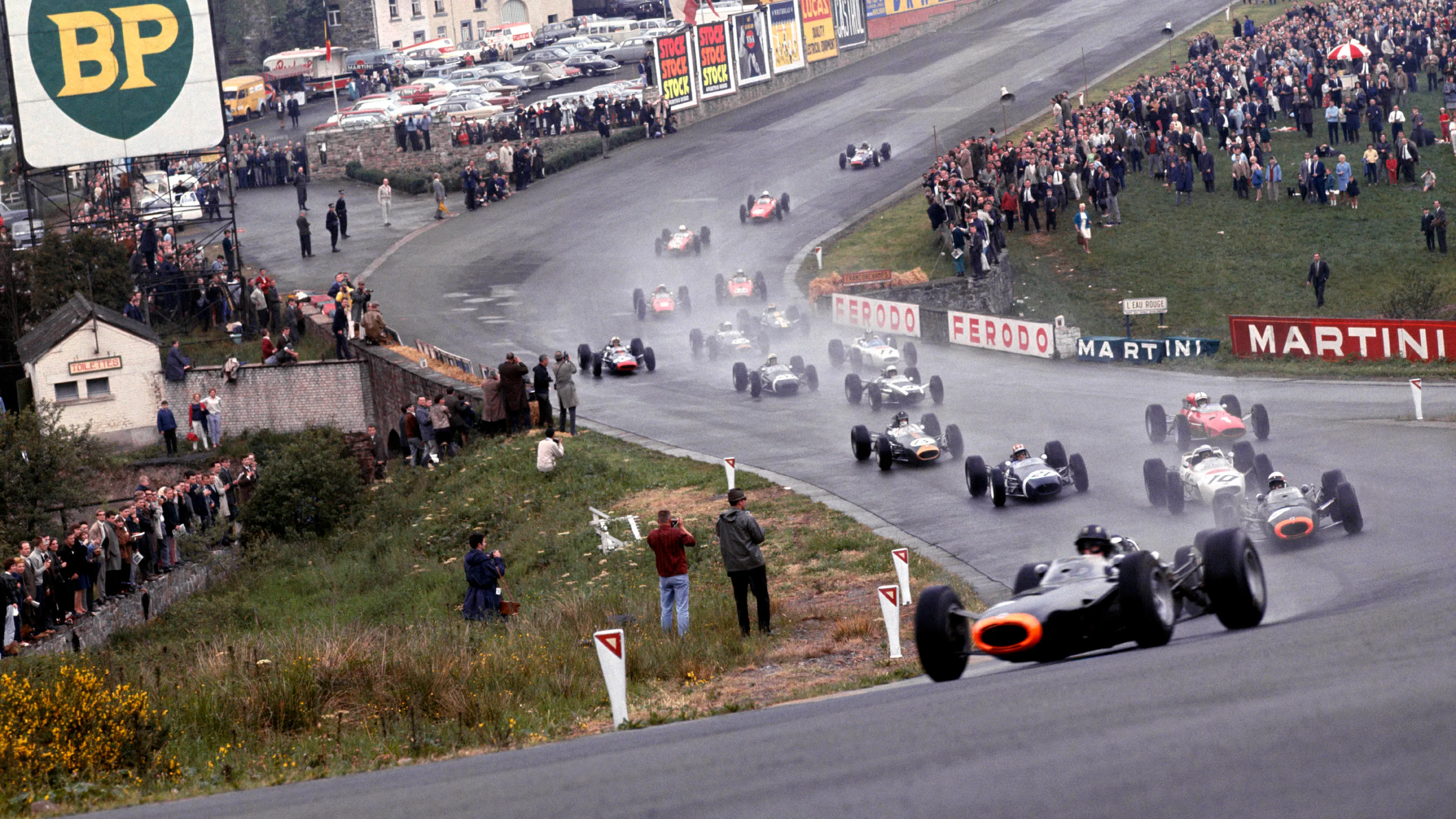 Graham Hill leads the field through Eau Rouge at the start of the 1965 Belgian Grand Prix. © LAT Photographic