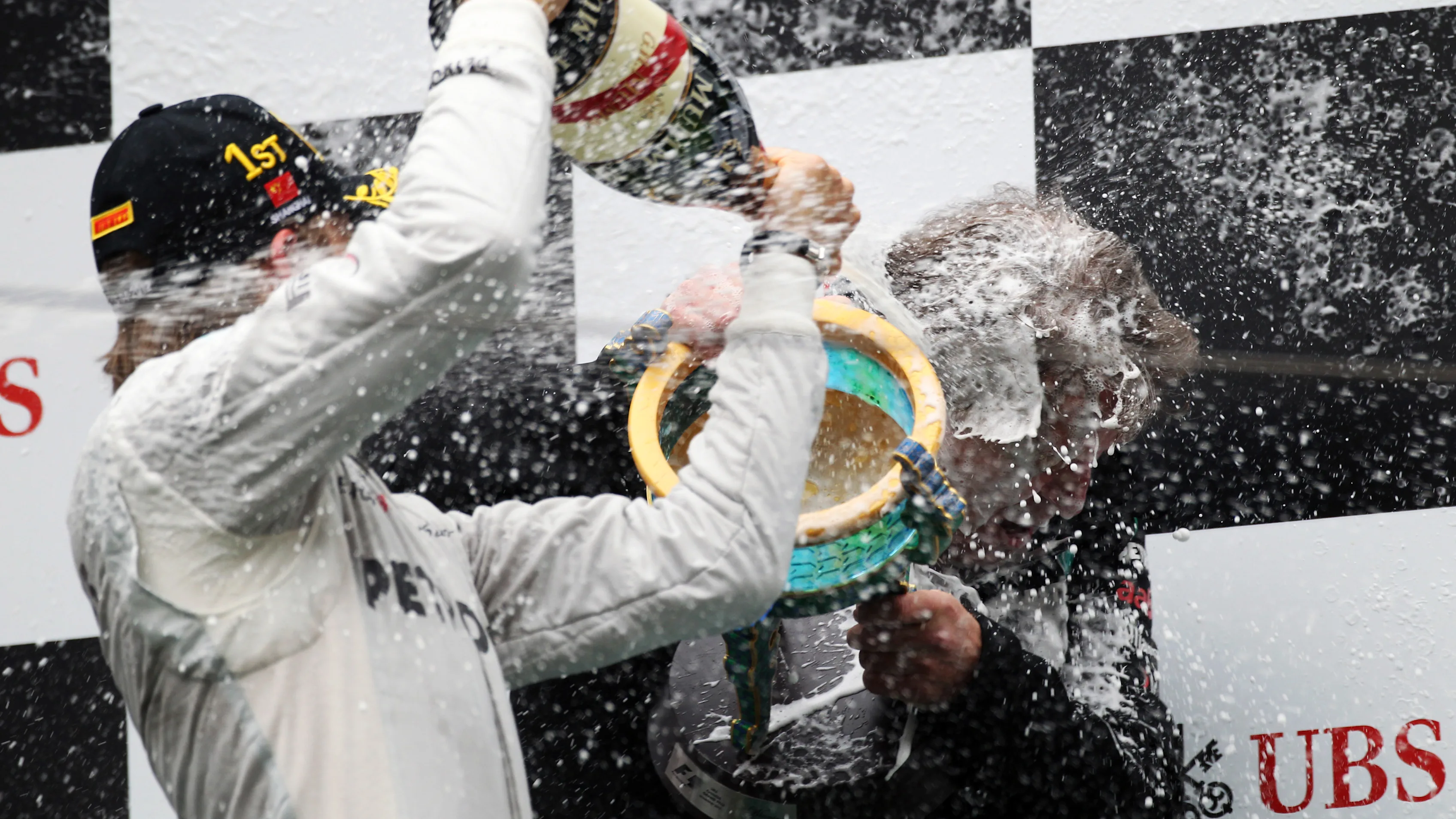 Race winner celebrates on the podium with the champagne and Norbert Haug (GER) Mercedes Sporting