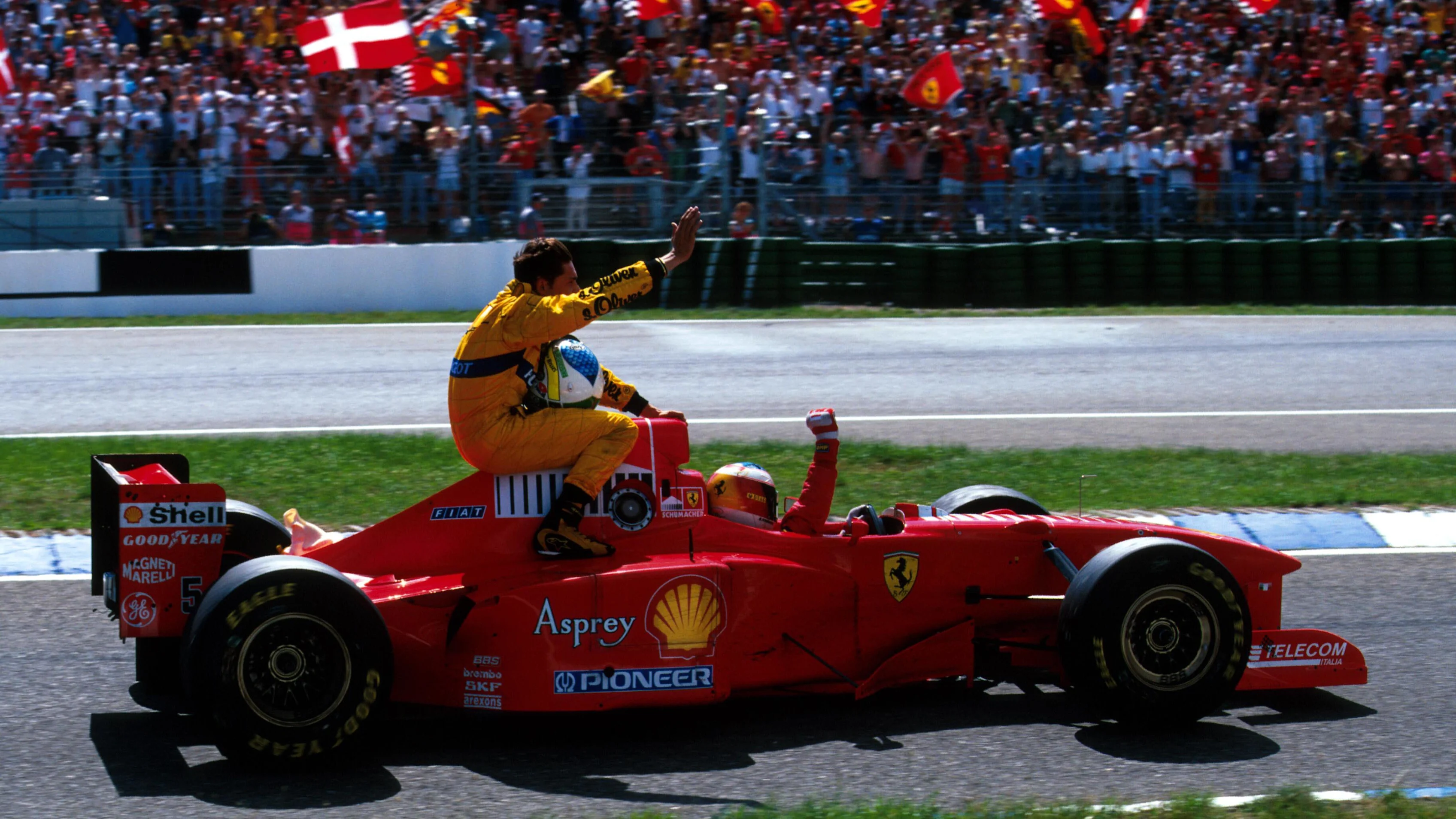 Giancarlo Fisichella (ITA) Jordan is given a lift back to the pits by Michael Schumacher (GER)
