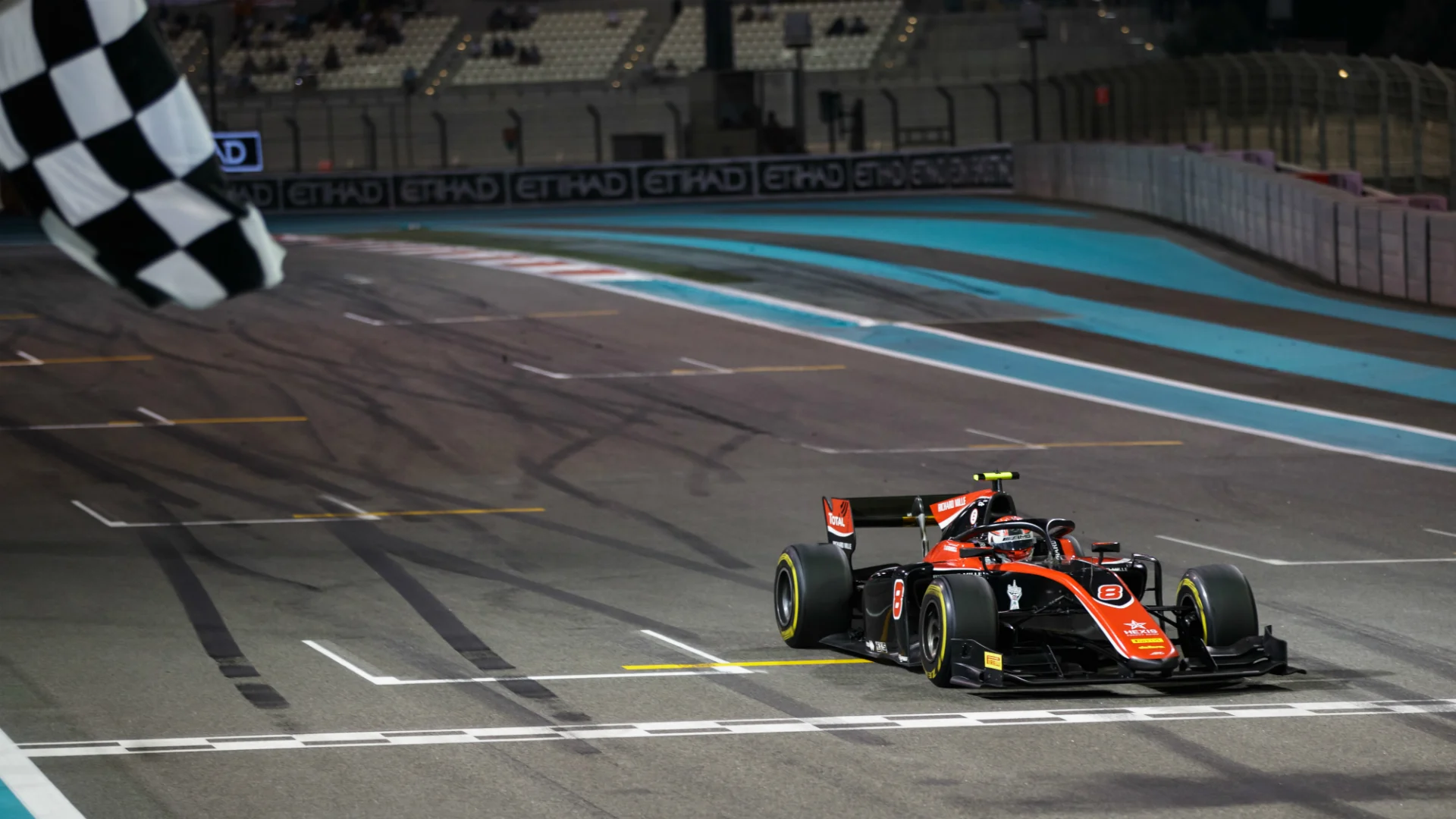 George Russell chequered flag Abu