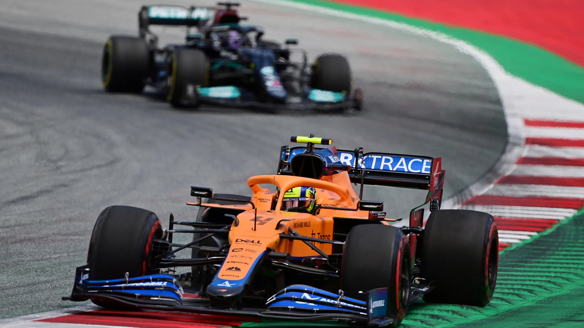 McLaren's British driver Lando Norris drives ahead of Mercedes' British driver Lewis Hamilton