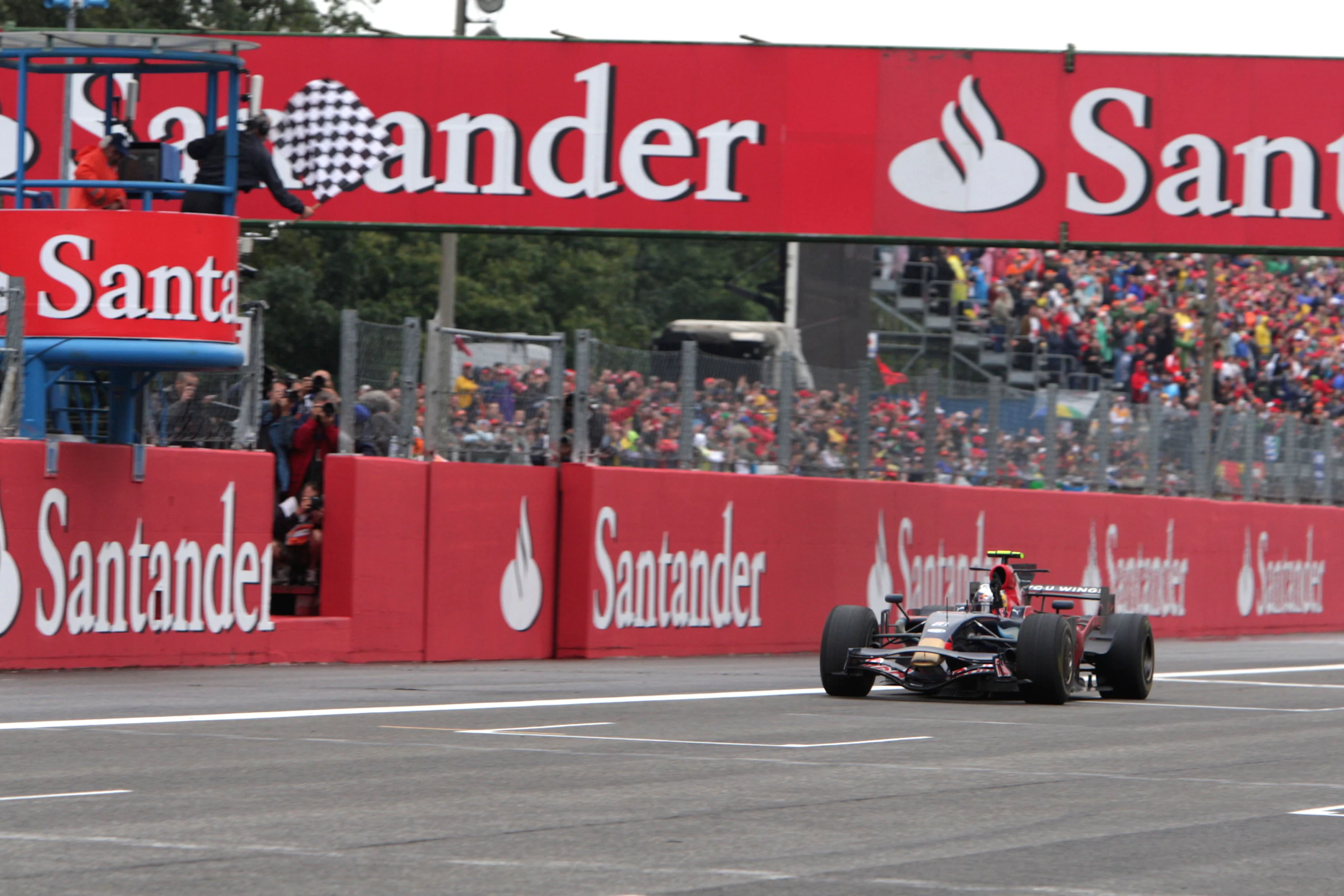 Sebastian Vettel (GER) Scuderia Toro Rosso STR03 passes the chequered flag to win Formula One