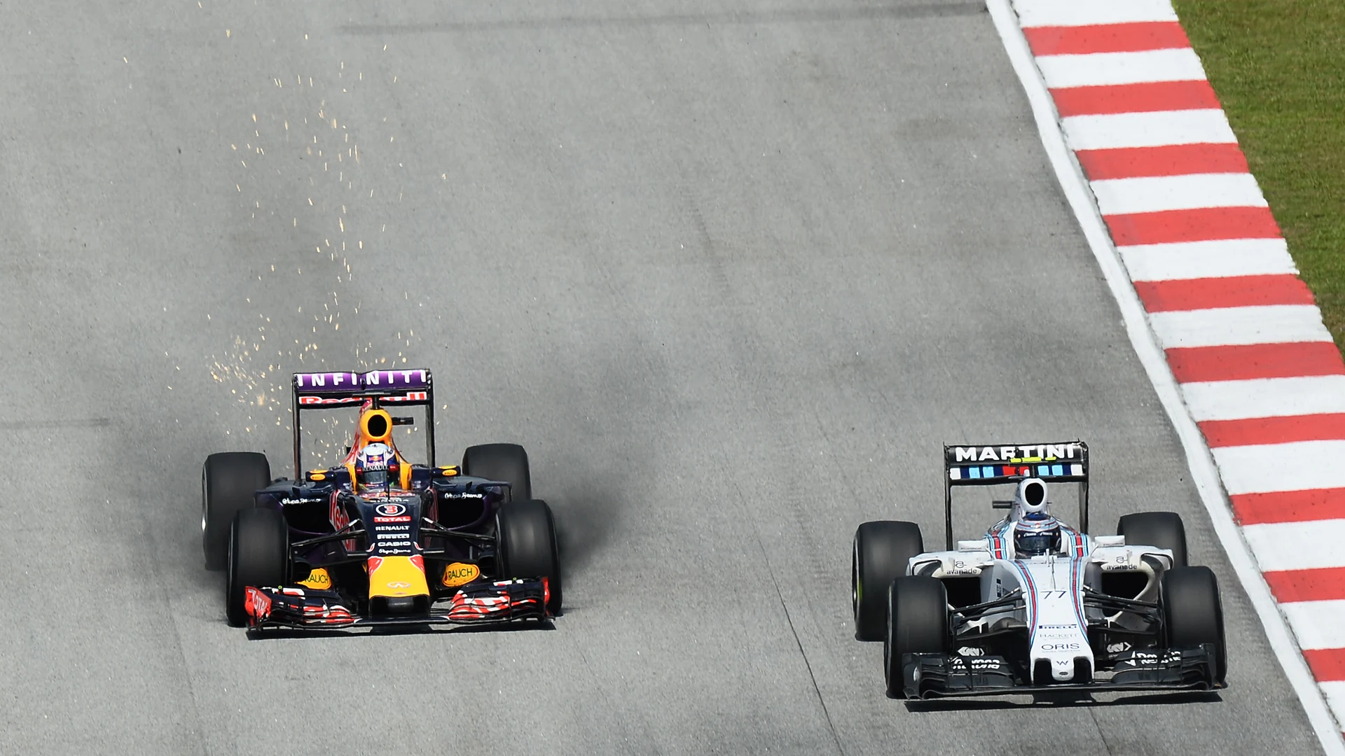 Daniel Ricciardo (AUS) Red Bull Racing RB11 with sparks and brake dust and Valtteri Bottas (FIN)