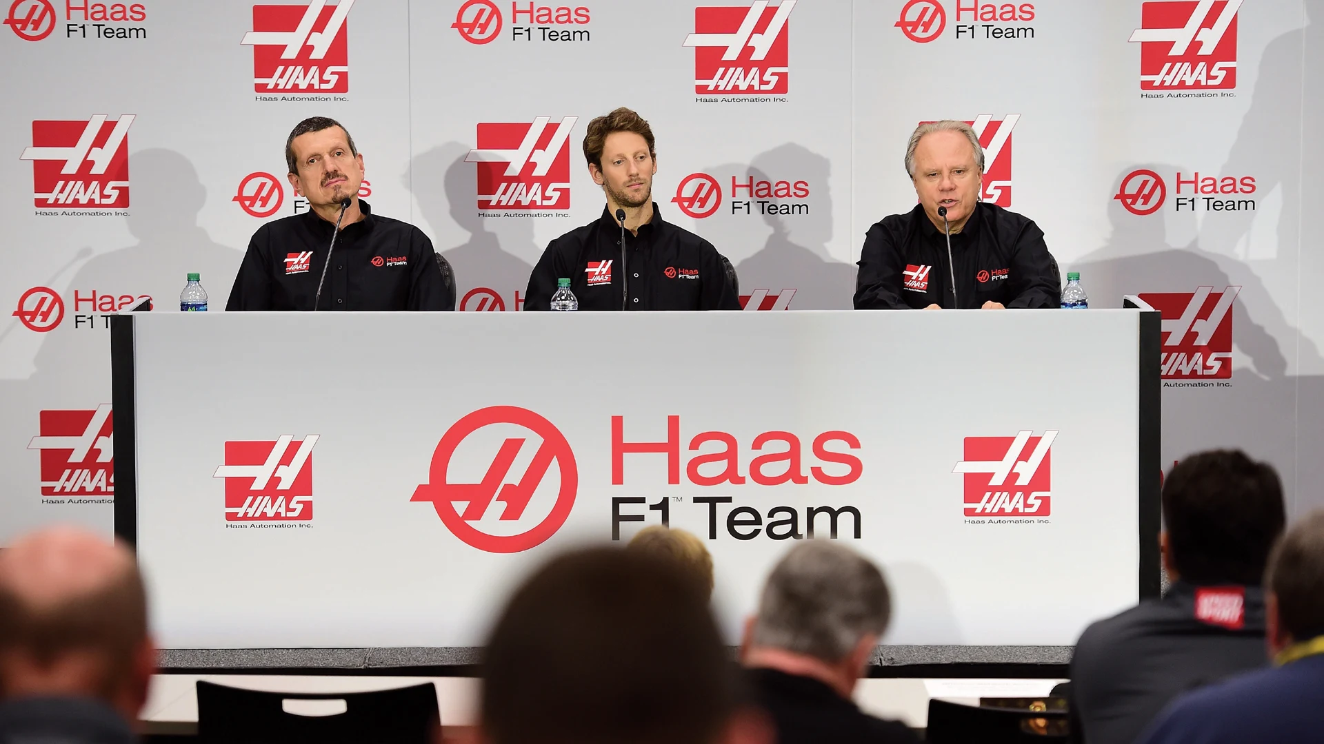 (R-L) Gene Haas, owner of Haas F1 Team, speaks with the media as Romain Grosjean of France and Guenther Steiner, team principal of Haas F1 Team, look on as Haas F1 Team announces Grosjean as their driver for the upcoming 2016 Formula 1 season on September 29, 2015 in Kannapolis, North Carolina © 2015 Getty Images