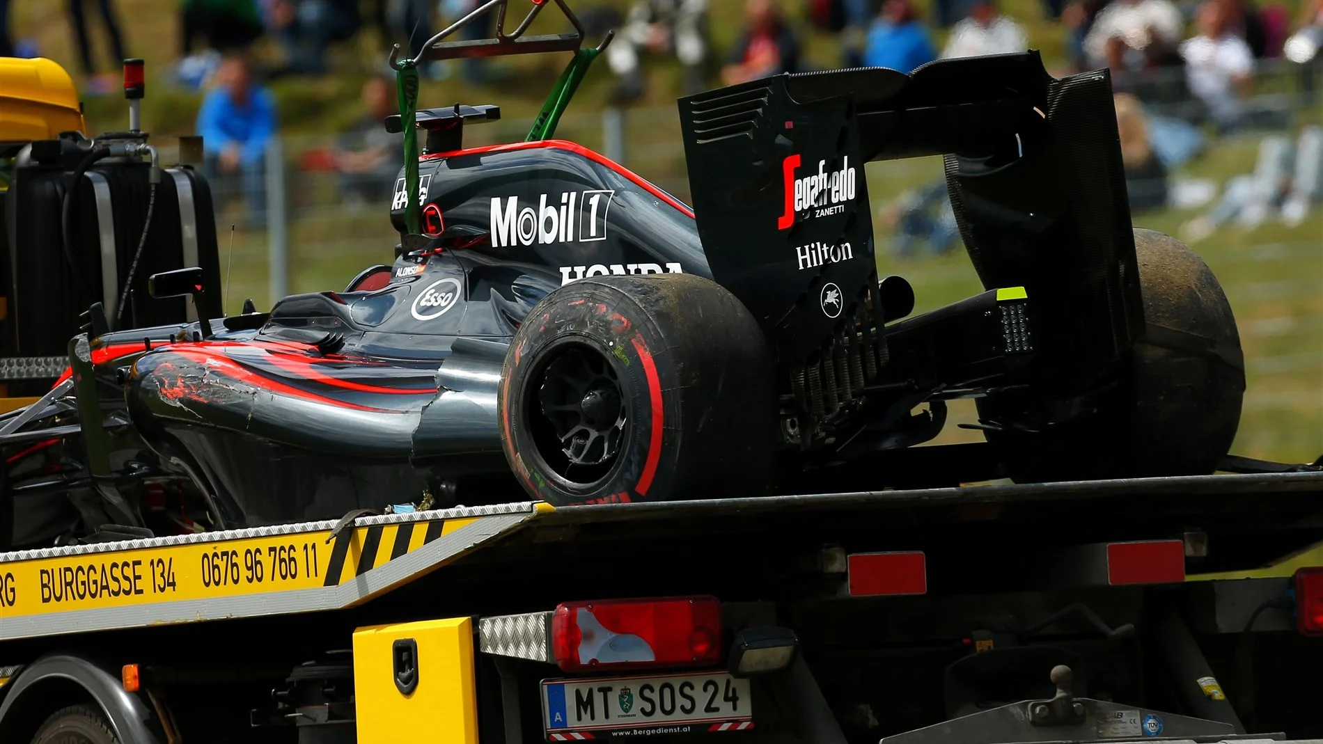 The car of race retiree Fernando Alonso (ESP) McLaren MP4-30 is recovered at Formula One World Championship, Rd8, Austrian Grand Prix, Race, Spielberg, Austria, Sunday 21 June 2015. © Sutton Motorsport Images