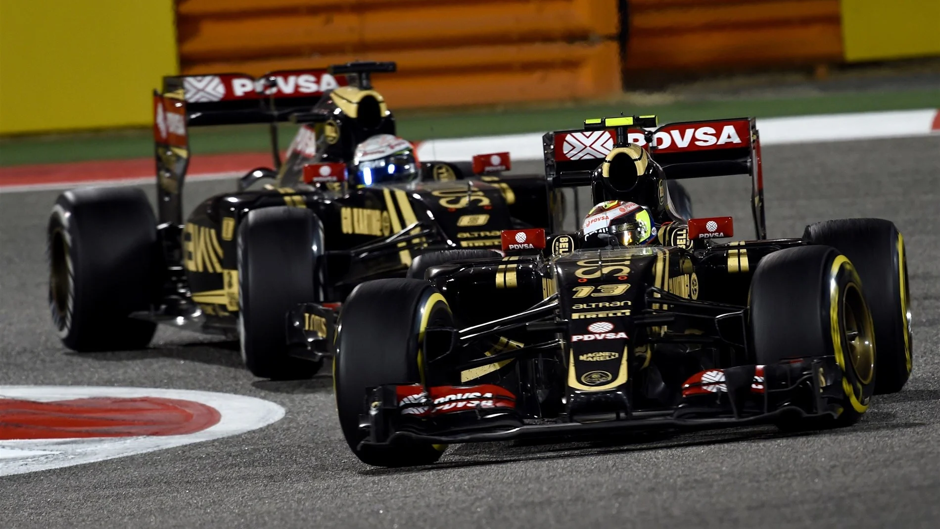 Pastor Maldonado (VEN) Lotus E23 Hybrid leads Romain Grosjean (FRA) Lotus E23 Hybrid at Formula One