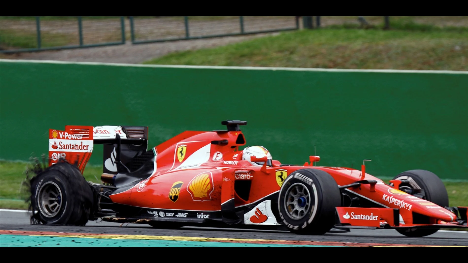 Sebastian Vettel (GER) Ferrari SF15-T with rear puncture at Formula One World Championship, Rd11,