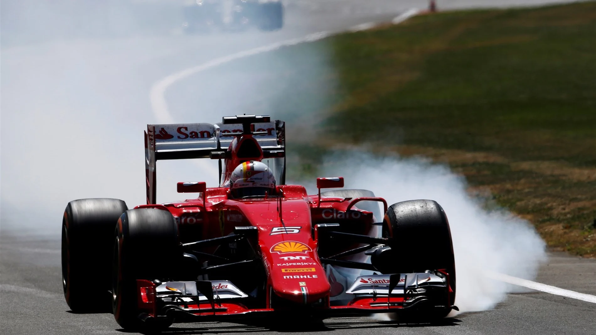 Sebastian Vettel (GER) Ferrari SF15-T locks up at Formula One World Championship, Rd9, British