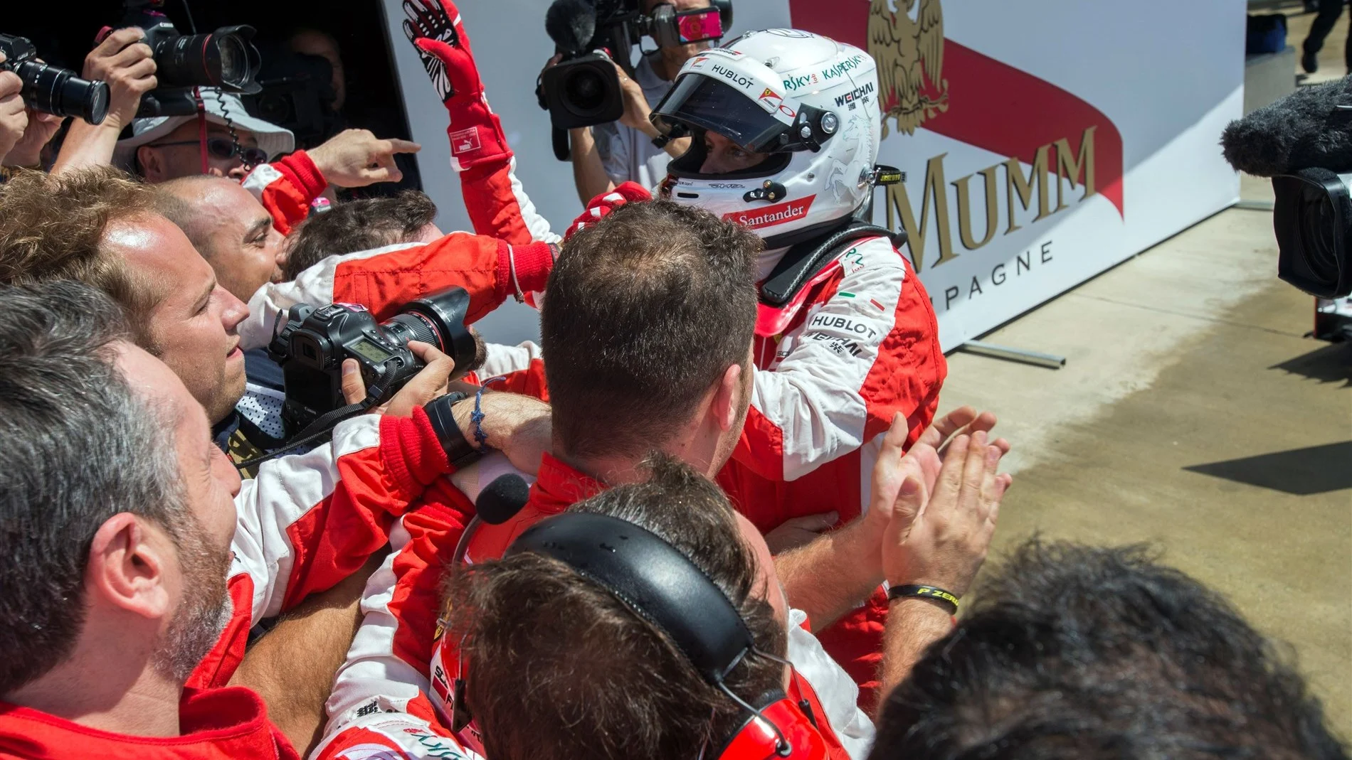 Sebastian Vettel (GER) Ferrari celebrates with the team in parc ferme at Formula One World