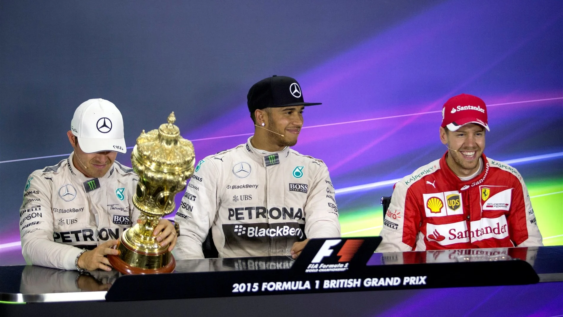 Nico Rosberg (GER) Mercedes AMG F1, Lewis Hamilton (GBR) Mercedes AMG F1 and Sebastian Vettel (GER) Ferrari in the press conference with the trophy   at Formula One World Championship, Rd9, British Grand Prix, Race, Silverstone, England, Sunday 5 July 2015. © Sutton Motorsport Images