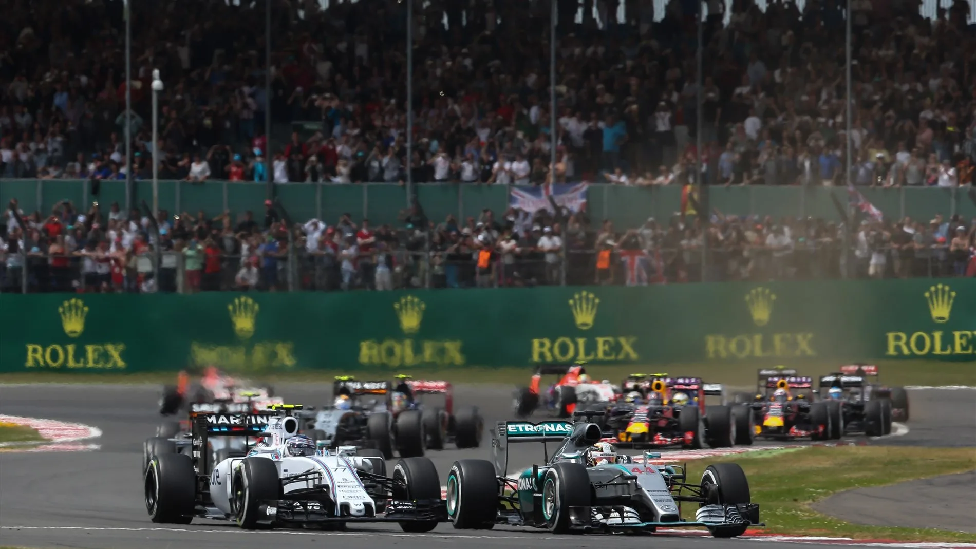 Valtteri Bottas (FIN) Williams FW37 and Lewis Hamilton (GBR) Mercedes AMG F1 W06 at the start of