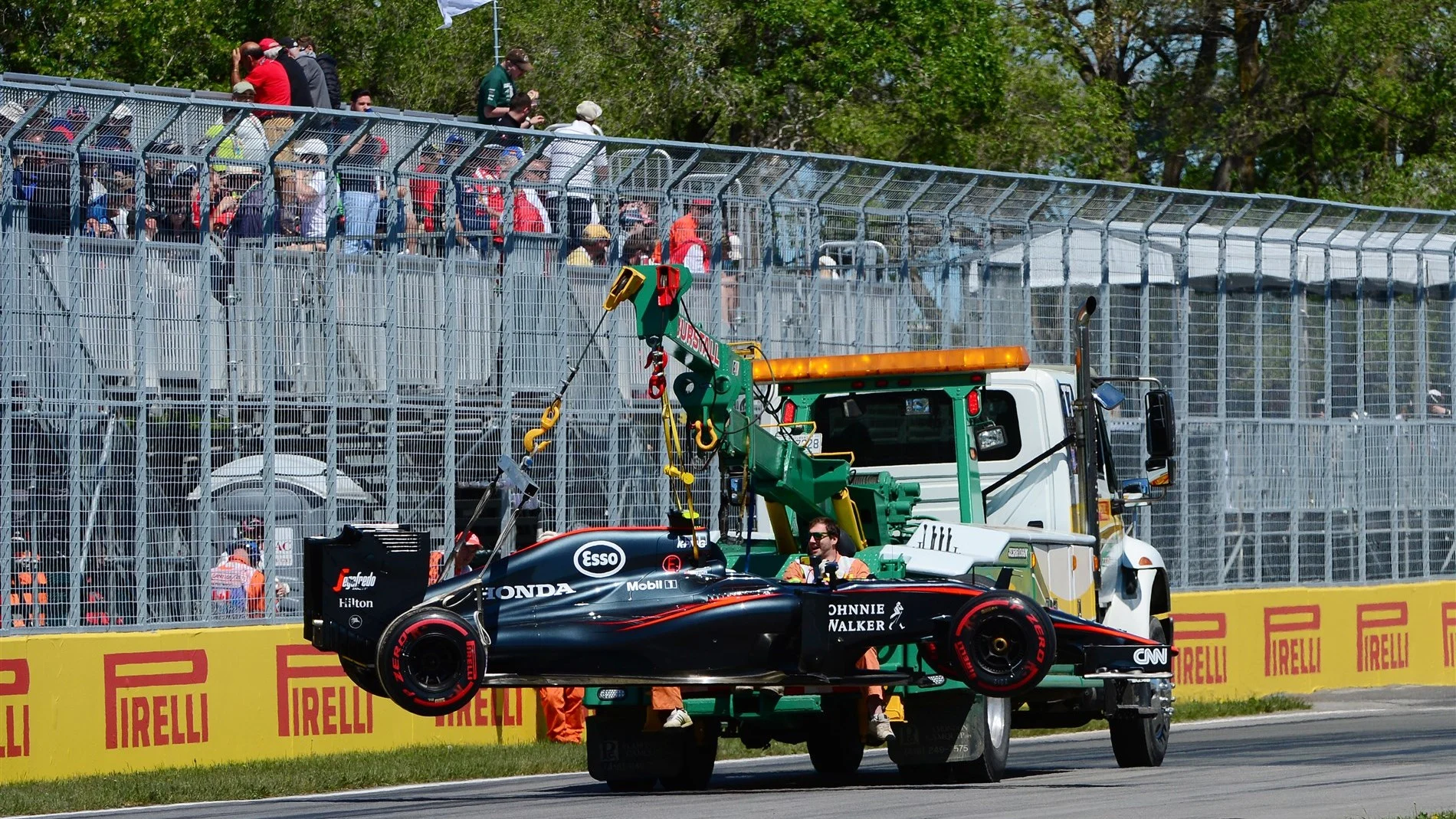 Jenson Button (GBR) McLaren car is recovered to the pits in FP3 at Formula One World Championship,