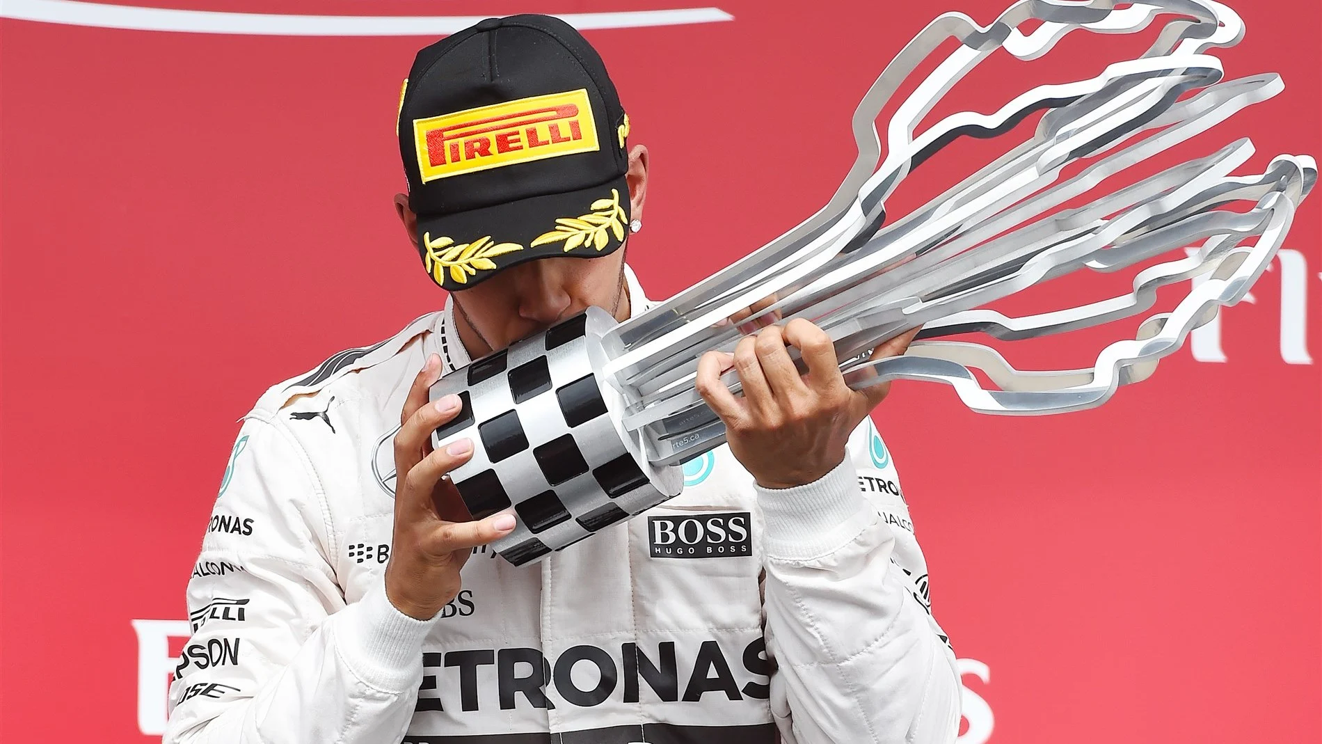 race winner Lewis Hamilton (GBR) Mercedes AMG F1 Celebrates celebrates on the podium with the