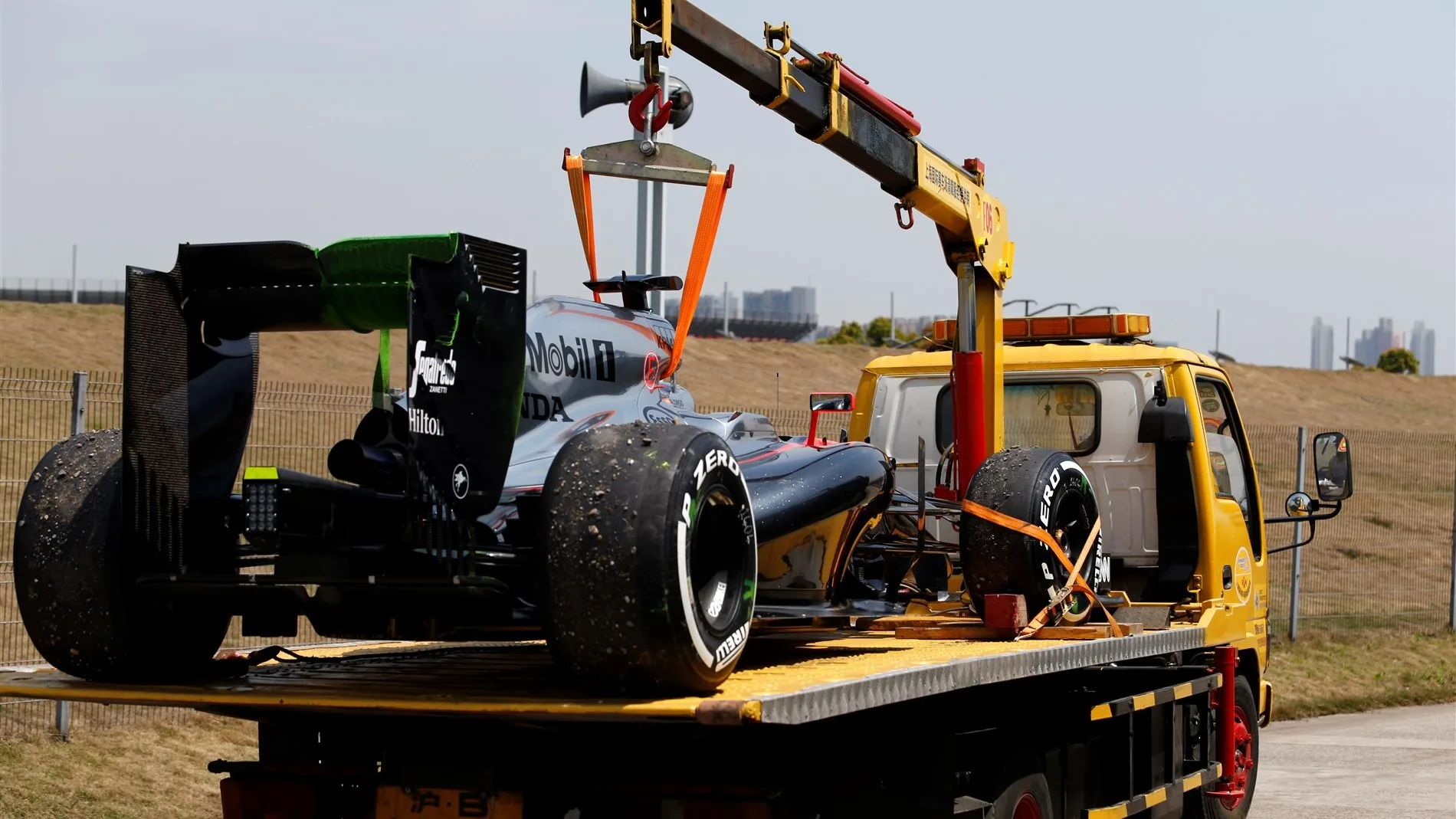 The car of Fernando Alonso (ESP) McLaren MP4-30 is recovered after stopping on track in FP3 at Formula One World Championship, Rd3, Chinese Grand Prix, Qualifying, Shanghai, China, Saturday 11 April 2015. © Sutton Motorsport Images