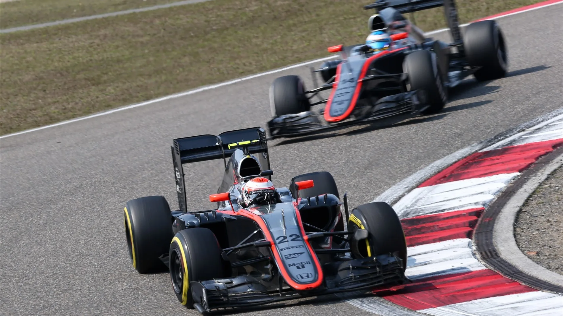 Jenson Button (GBR) McLaren MP4-30 leading Fernando Alonso (ESP) McLaren MP4-30 at Formula One