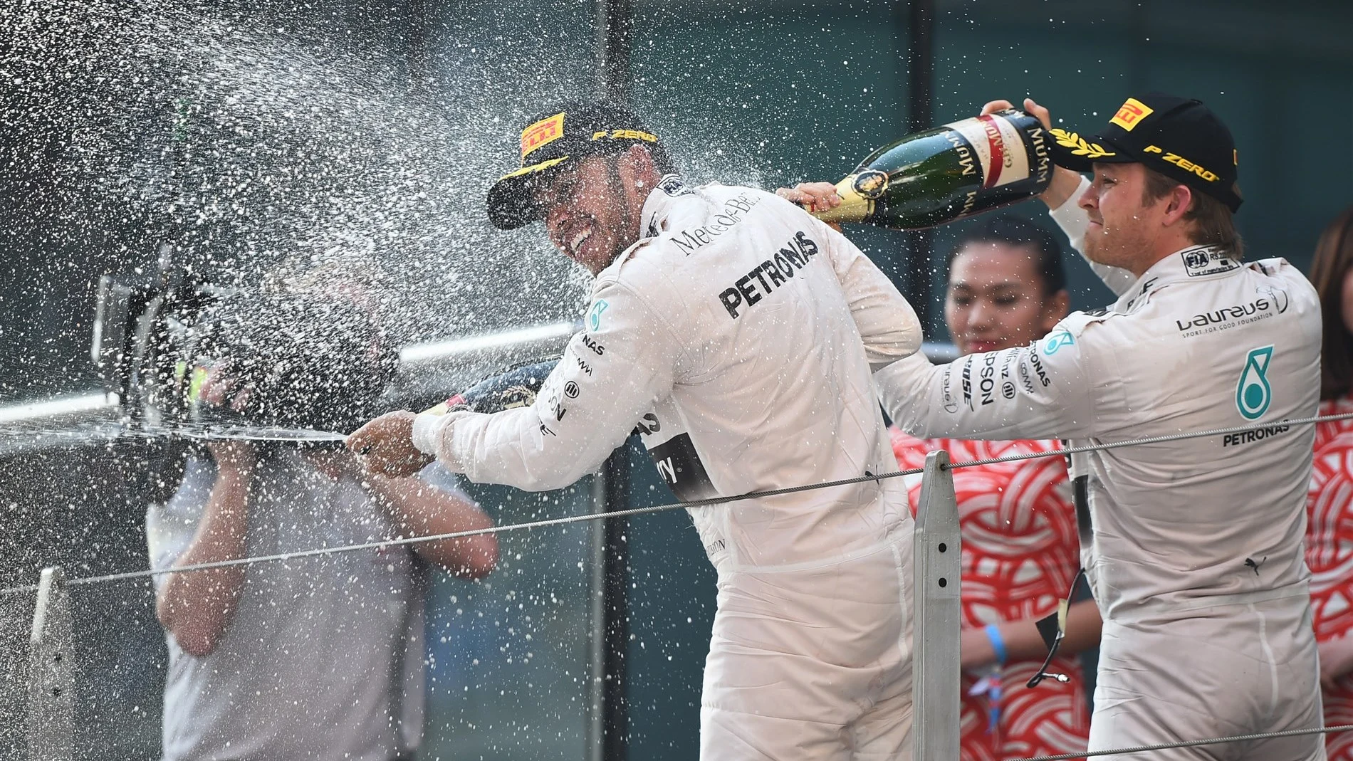 Lewis Hamilton (GBR) Mercedes AMG F1 celebrates his victory on the podium with Nico Rosberg (GER)