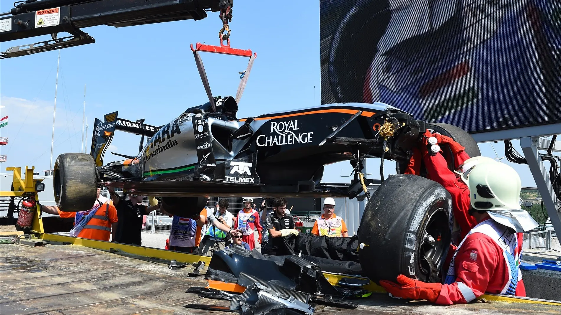 The crashed car of Sergio Perez (MEX) Force India VJM08 is recovered after rolling in FP1 at