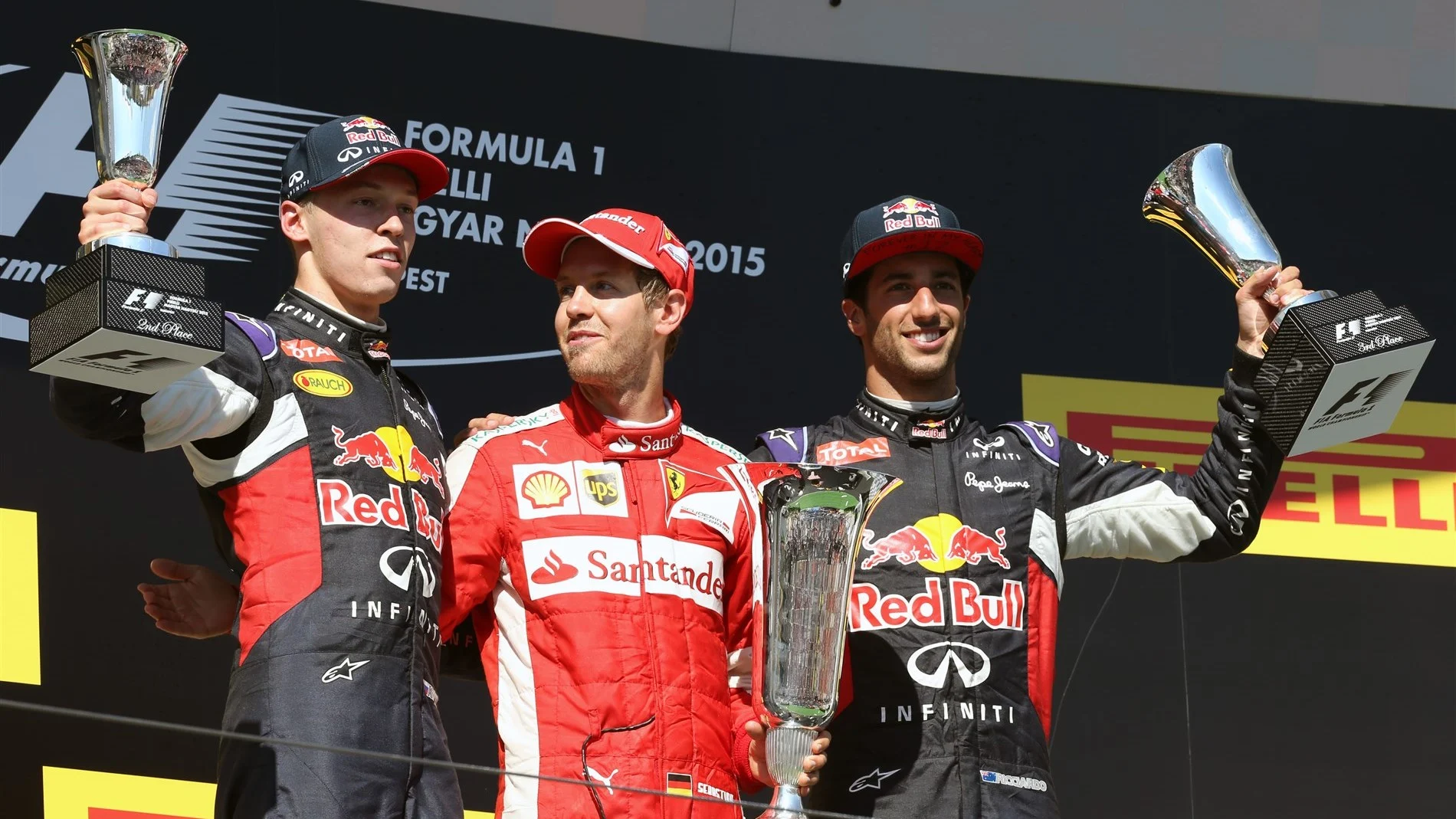 (L to R): Daniil Kyvat (RUS) Red Bull Racing, Race winner Sebastian Vettel (GER) Ferrari and Daniel Ricciardo (AUS) Red Bull Racing celebrate with the trophy on the podium at Formula One World Championship, Rd10, Hungarian Grand Prix, Race, Hungaroring, Hungary, Sunday 26 July 2015. © Sutton Motorsport Images
